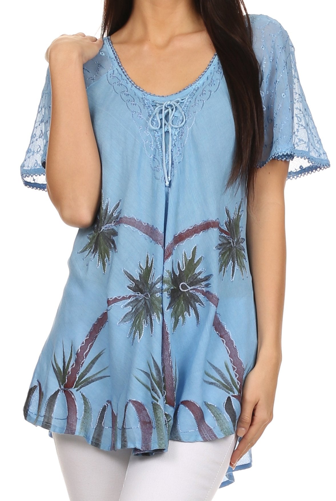 Woman wearing a blue lace-trimmed top with palm tree design