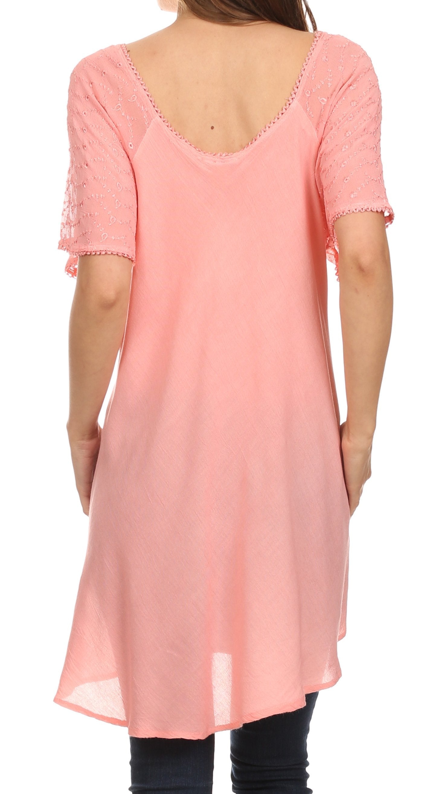 Pink tunic with lace details on a white background