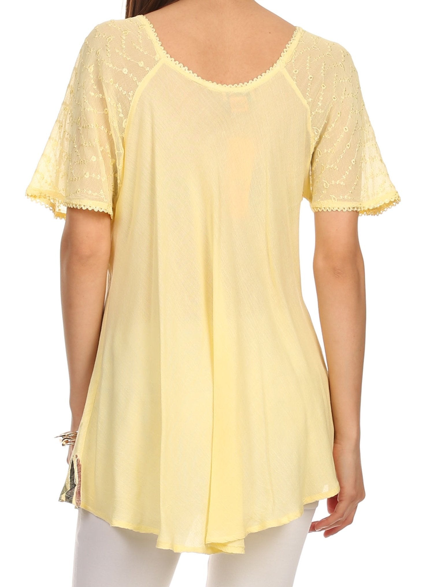 Yellow lace-trimmed top worn by a person on a white background
