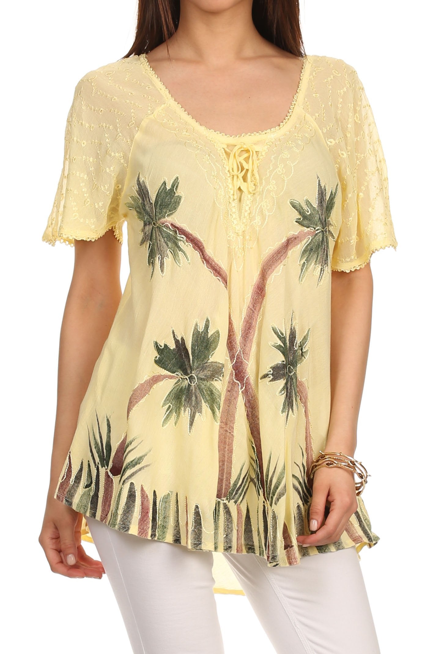 Woman wearing a yellow lace top with palm tree design