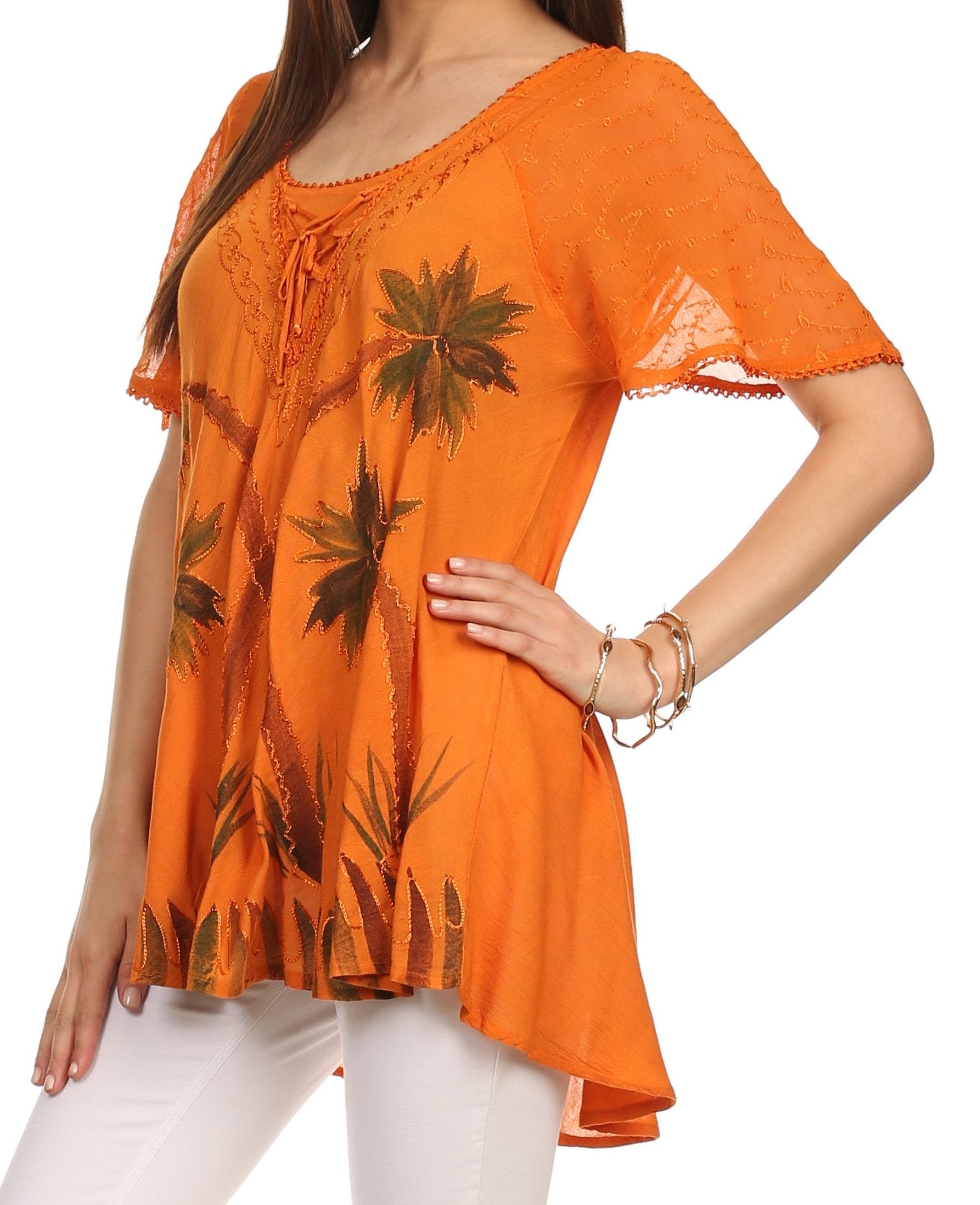 Orange floral blouse worn by a model on a white background