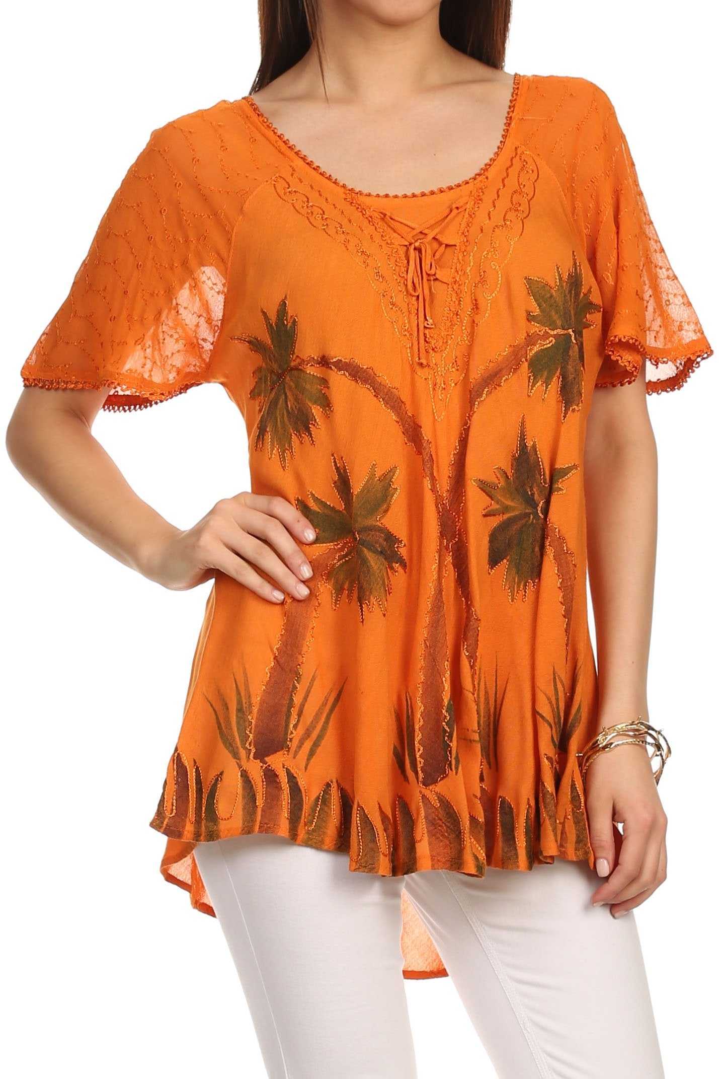 Orange blouse with palm tree pattern worn by a person on a white background