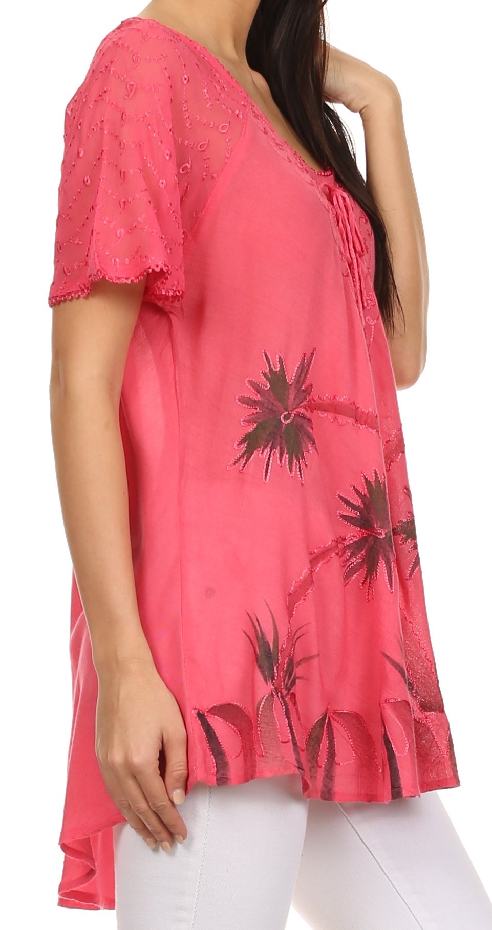 Pink blouse with black floral patterns worn by a person on a white background