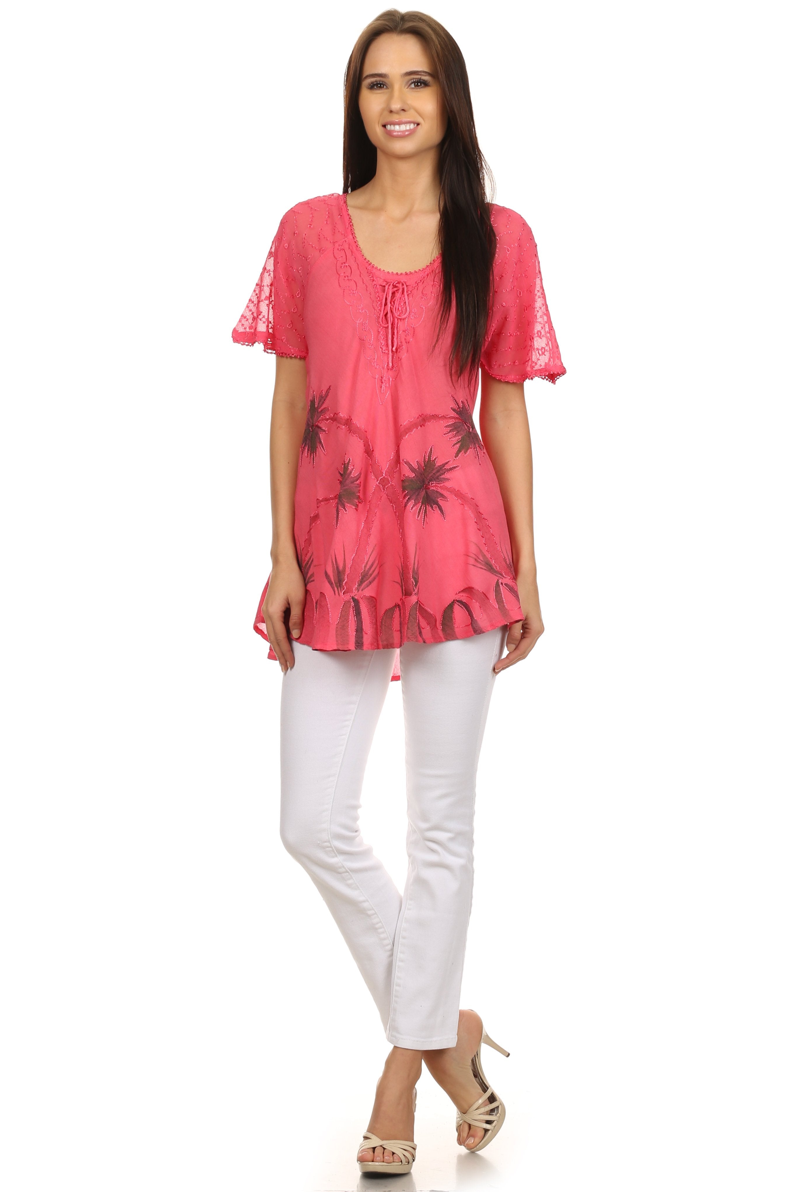 Woman wearing a pink floral top and white pants on a white background