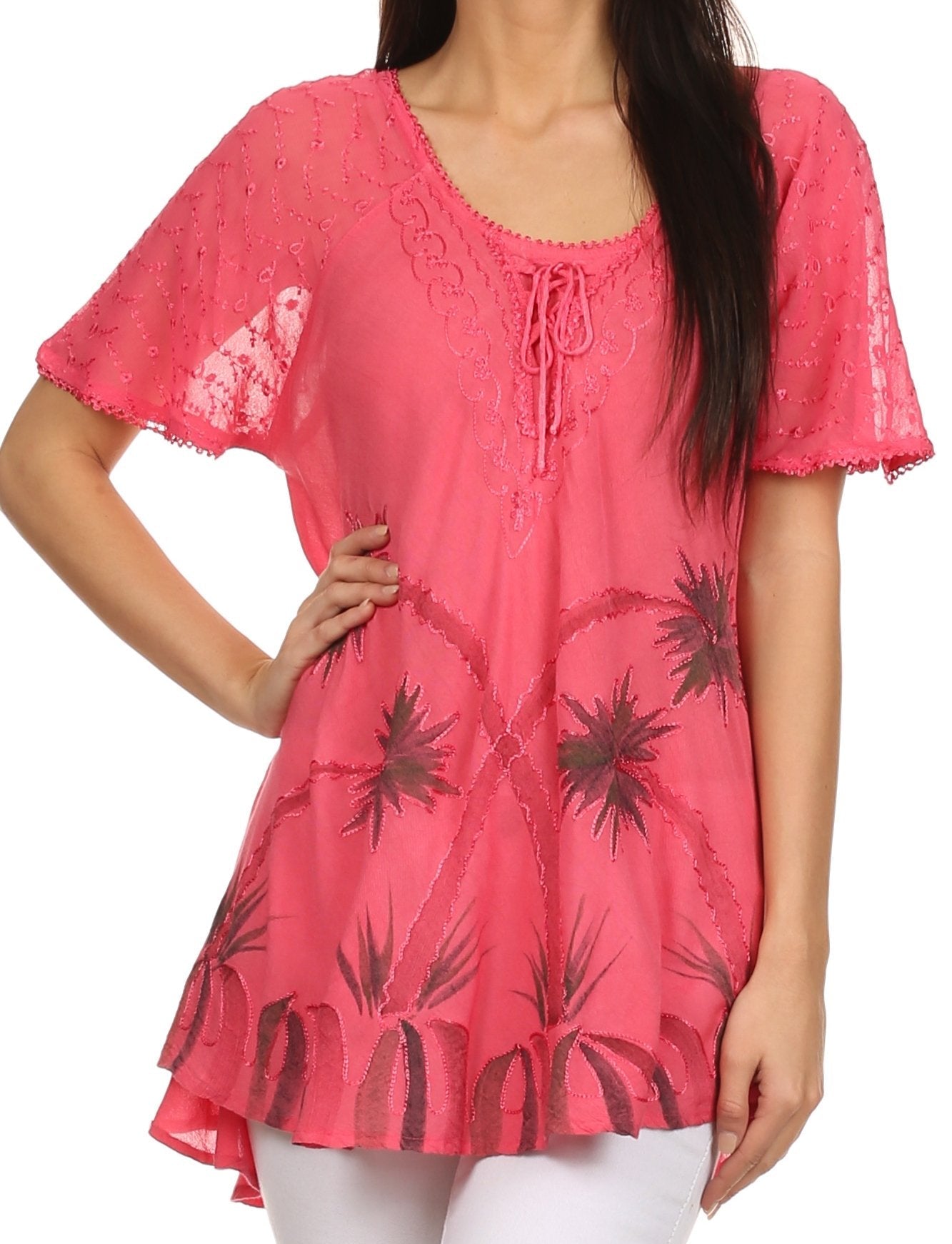 Pink lace top with floral pattern worn by a person on a white background