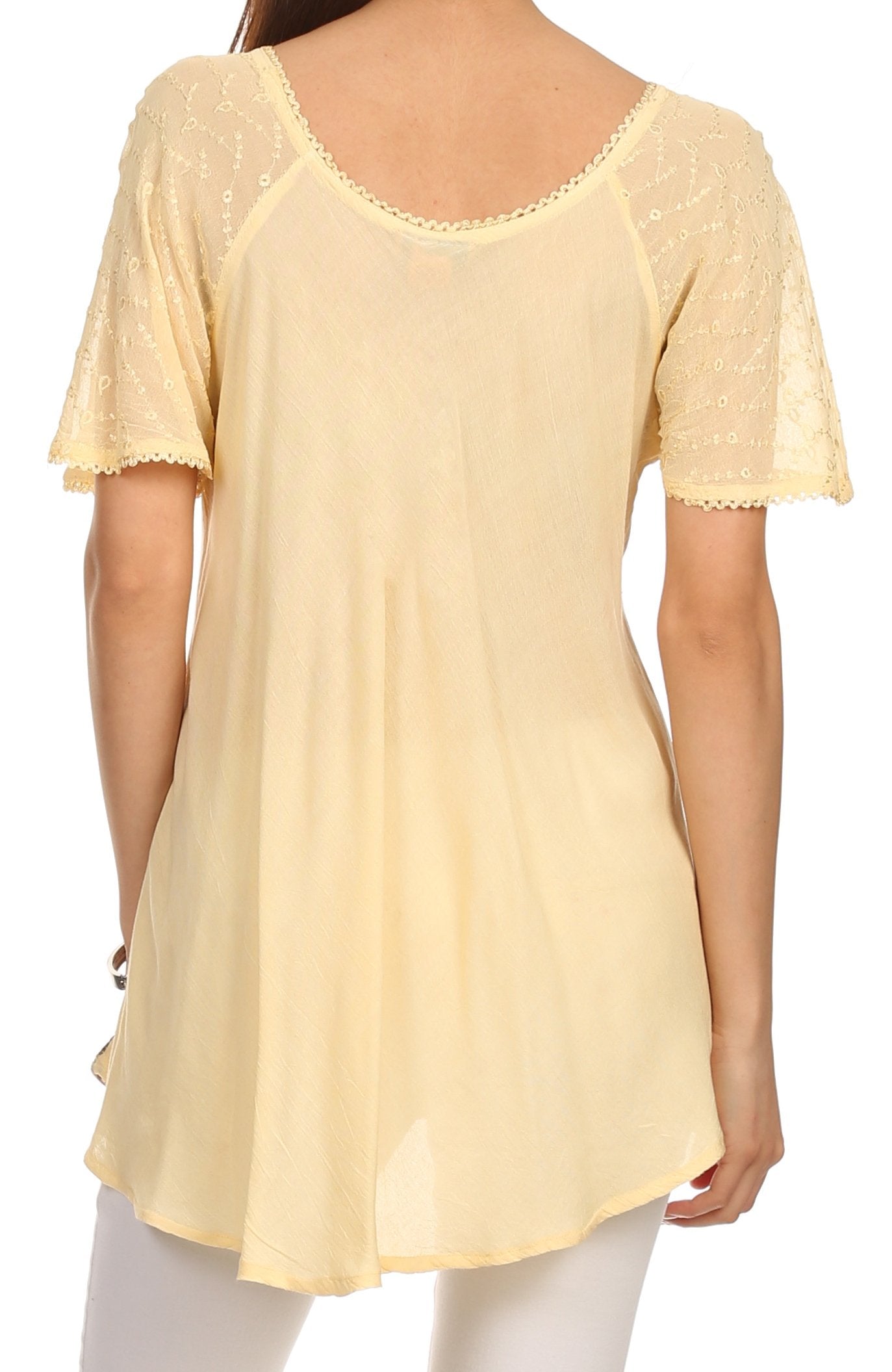 Yellow lace-trimmed top worn by a person on a white background