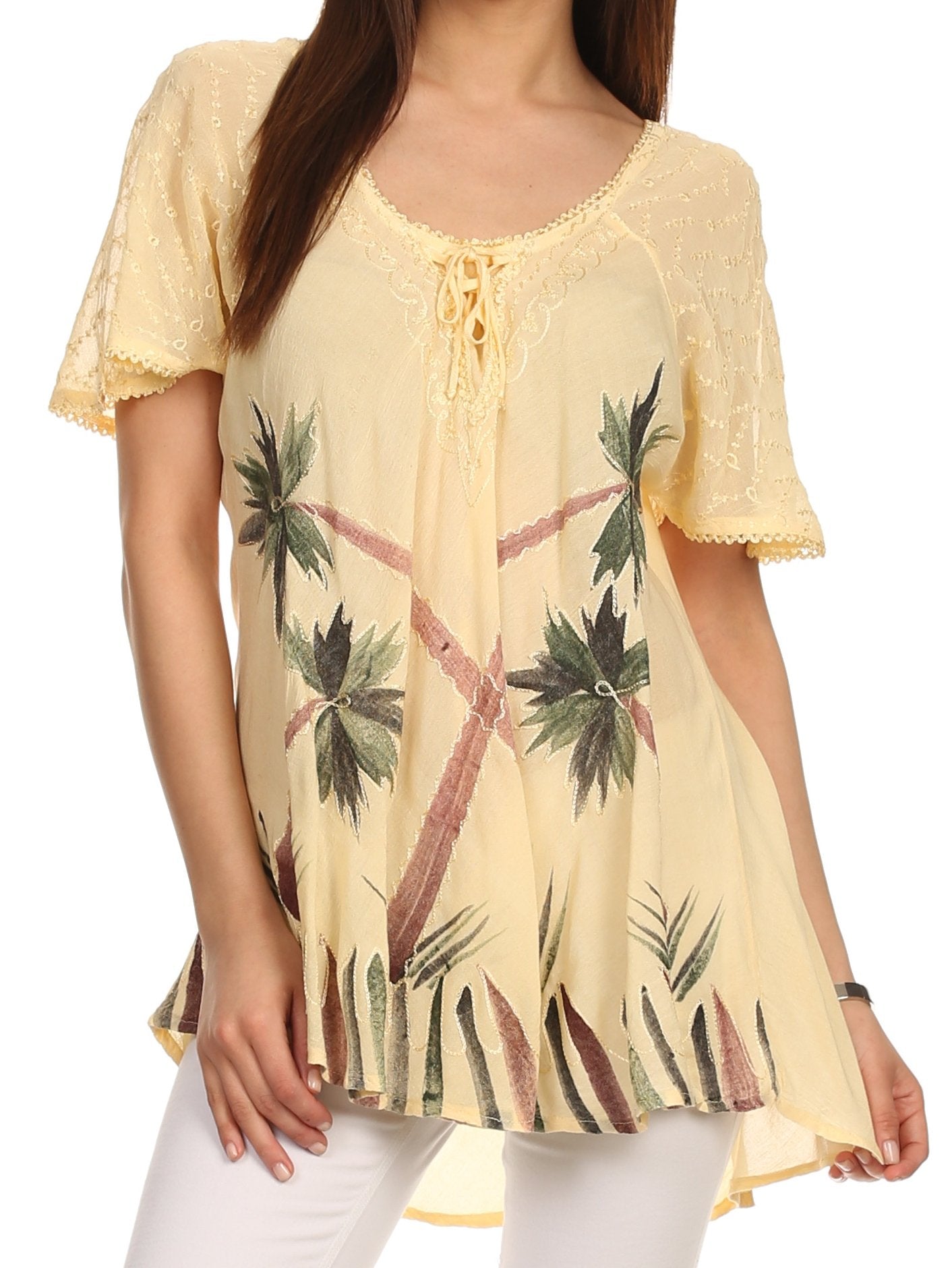 Woman wearing a yellow lace-trimmed top with palm tree pattern on a white background