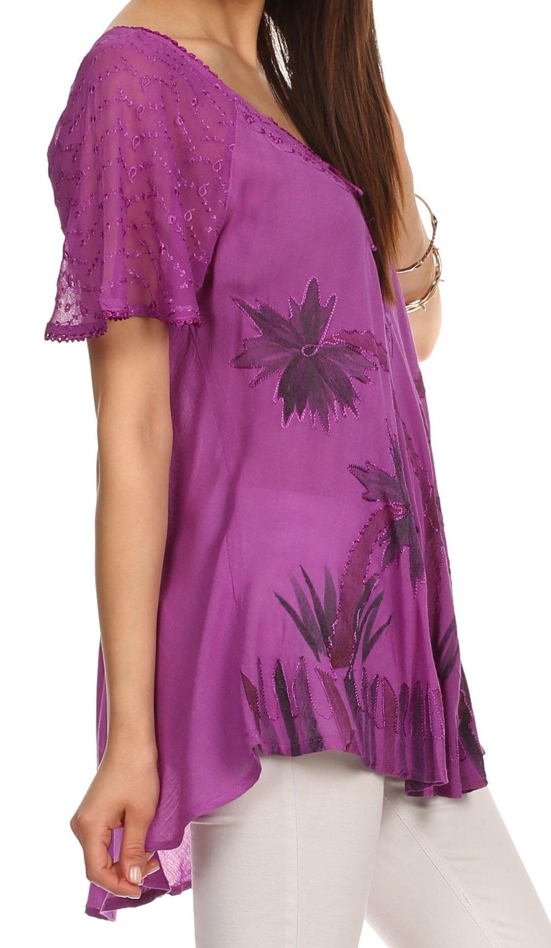 Purple lace top with floral patterns worn by a person on a white background