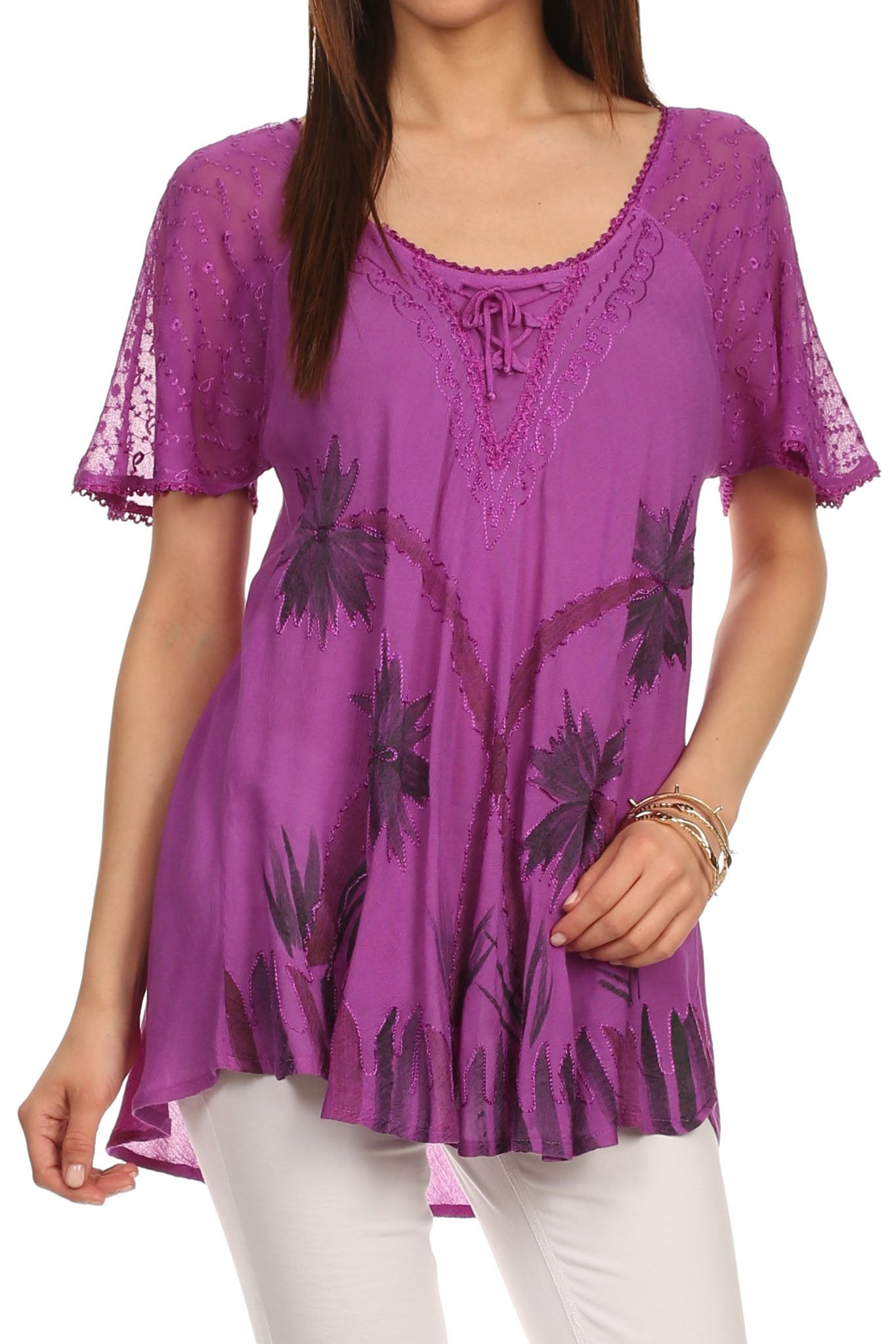Purple lace top with floral patterns worn by a model on a white background