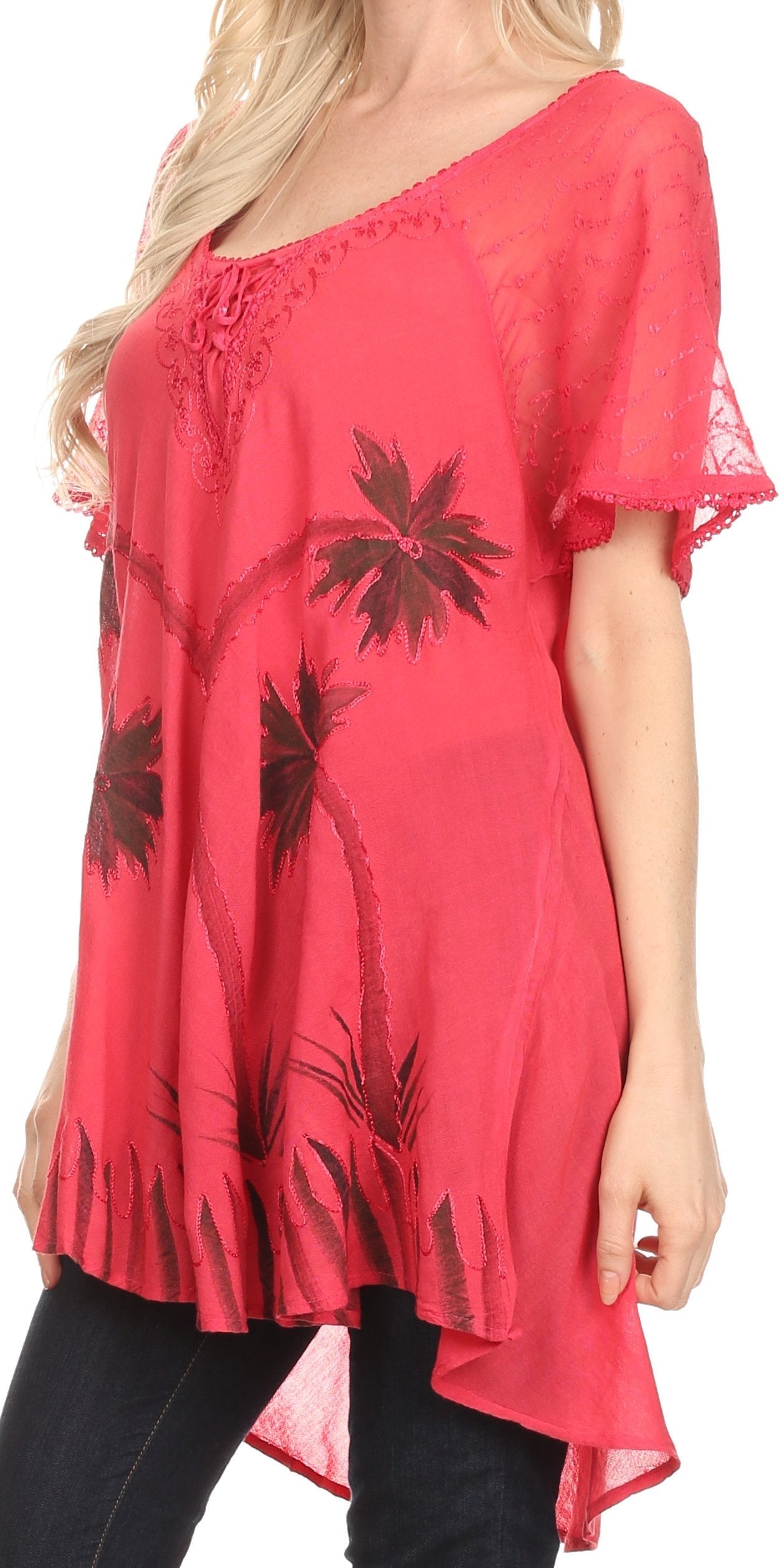 Red blouse with black floral patterns worn by a person on a white background