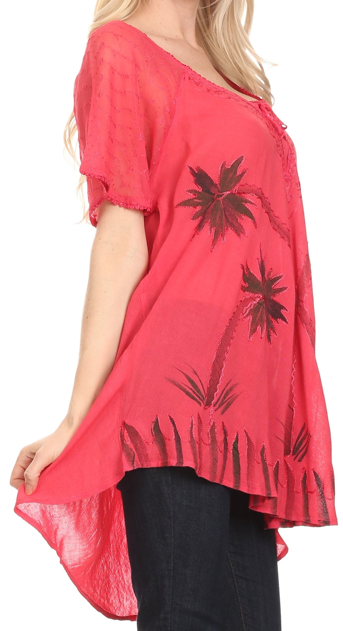Red tunic with black palm tree designs worn by a person on a white background