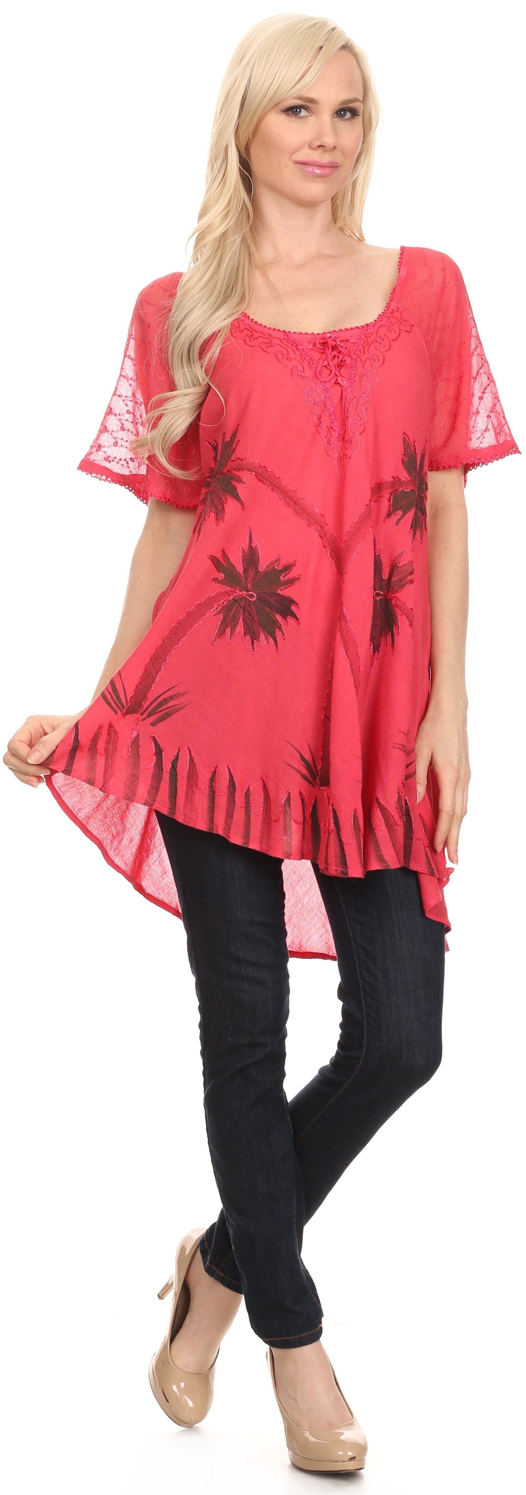 Woman wearing a red floral tunic and black pants on a white background