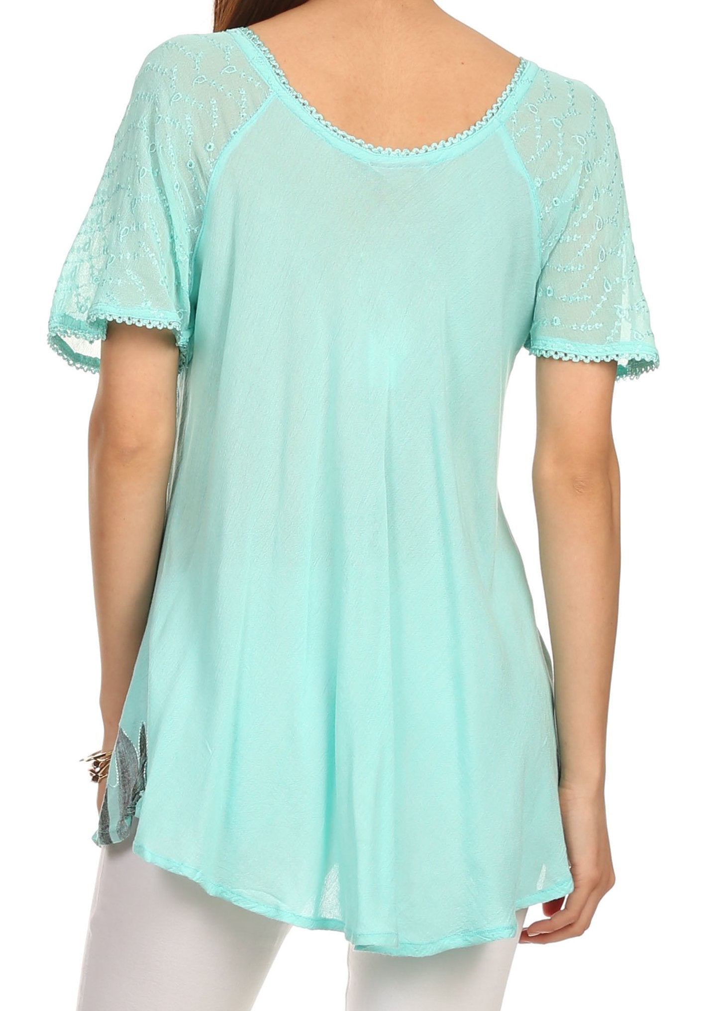 Mint green lace-trimmed top worn by a person on a white background