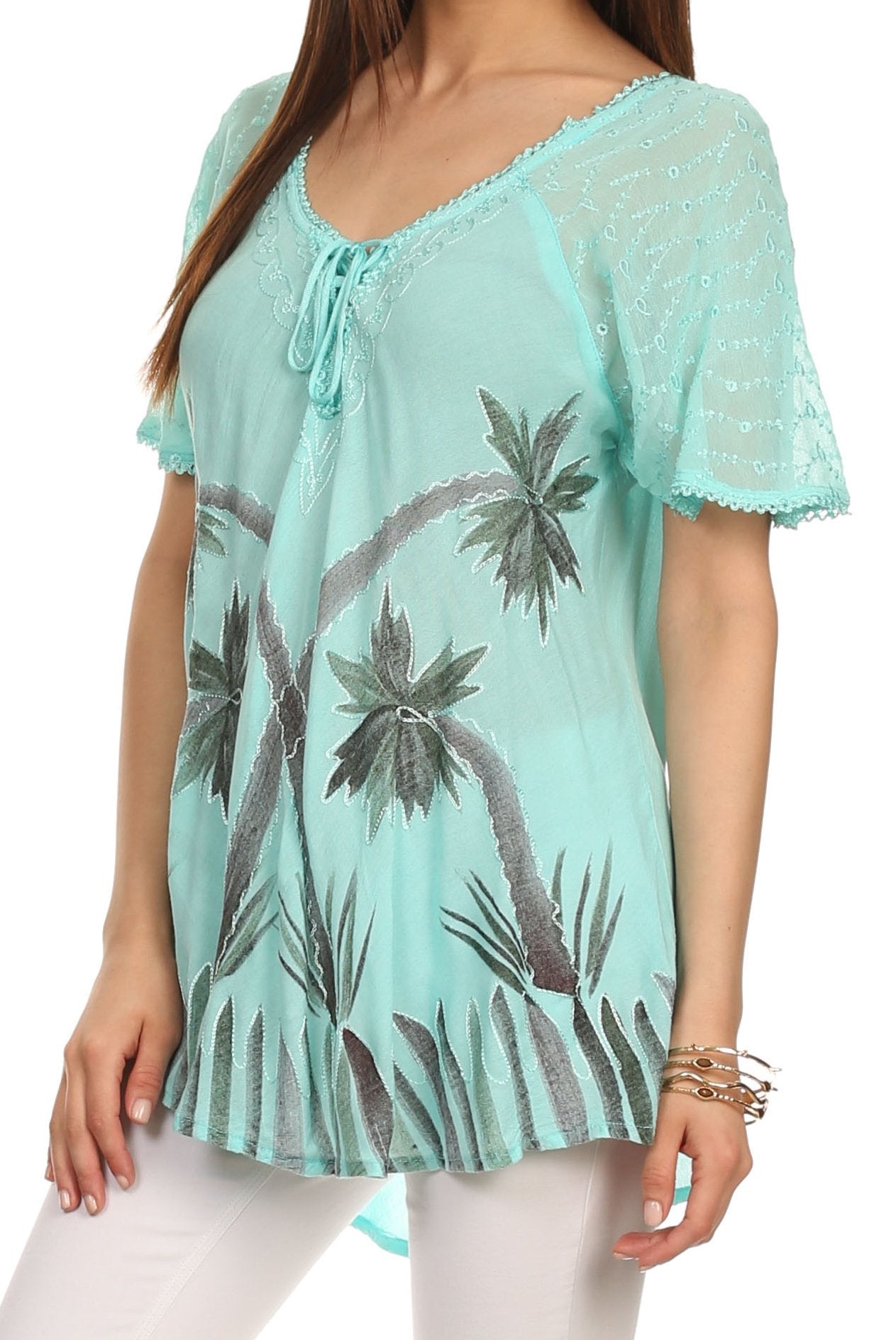 Mint green lace top with palm tree pattern worn by a person