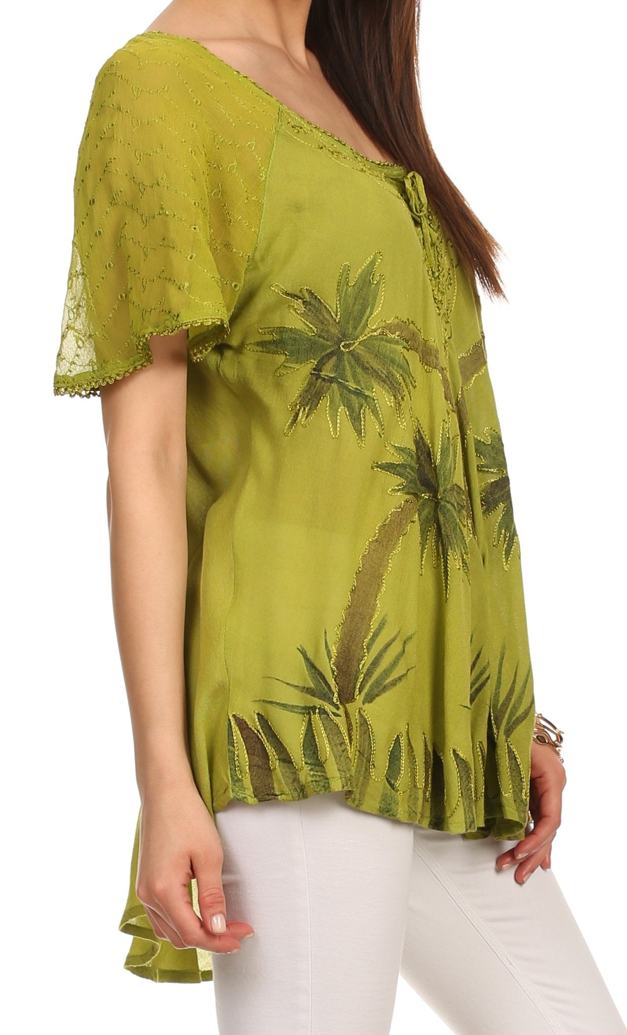 Green blouse with palm tree pattern worn by a person on a white background