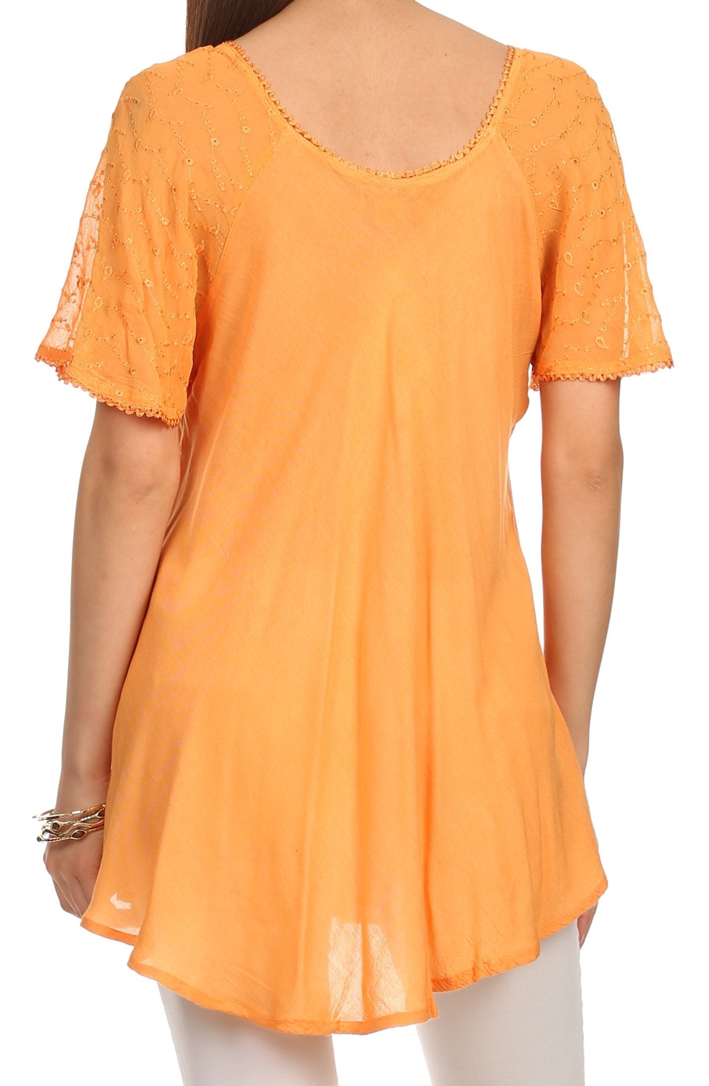 Orange lace-trimmed top worn by a person on a white background