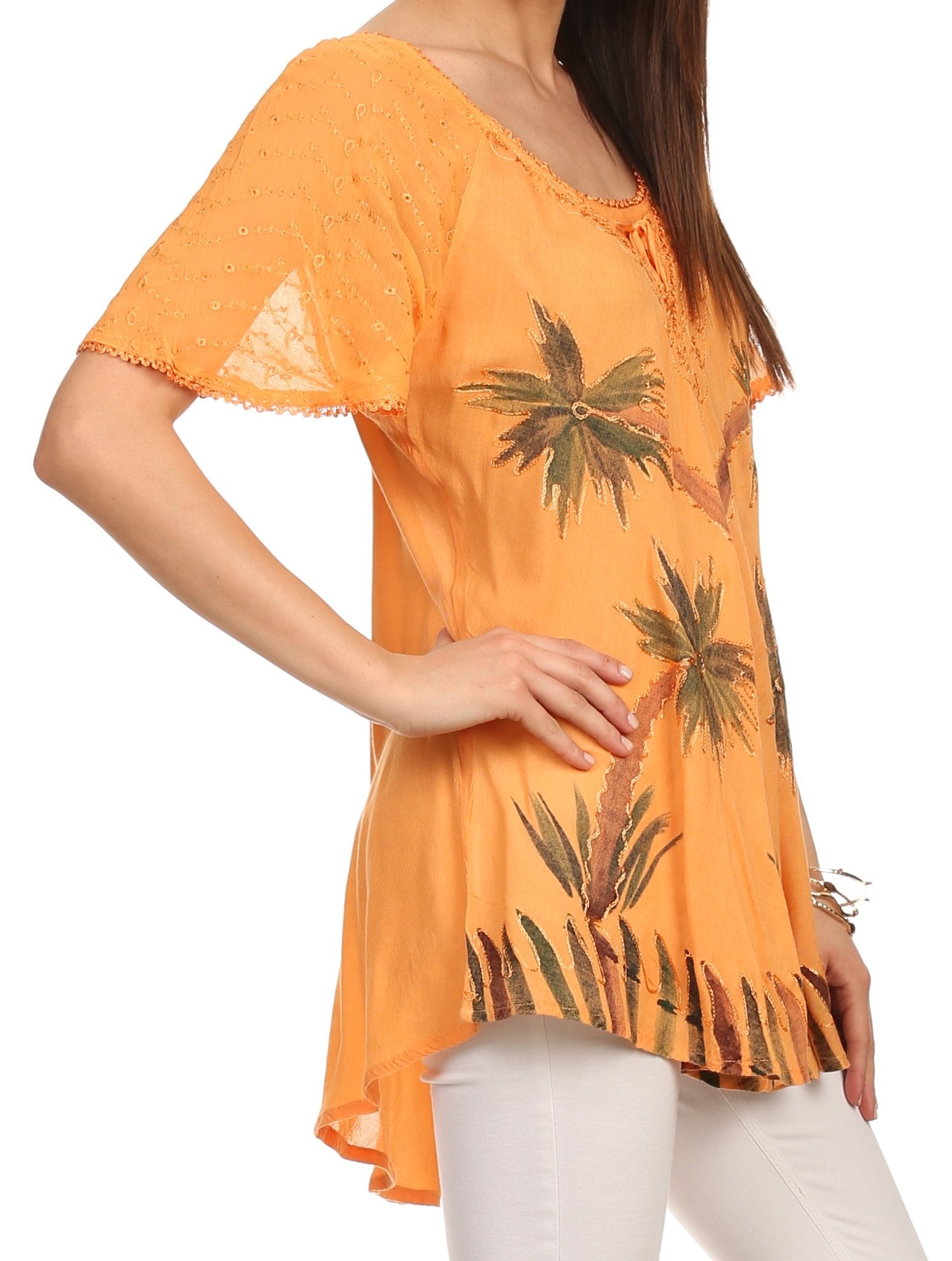 Orange blouse with palm tree pattern worn by a person on a white background
