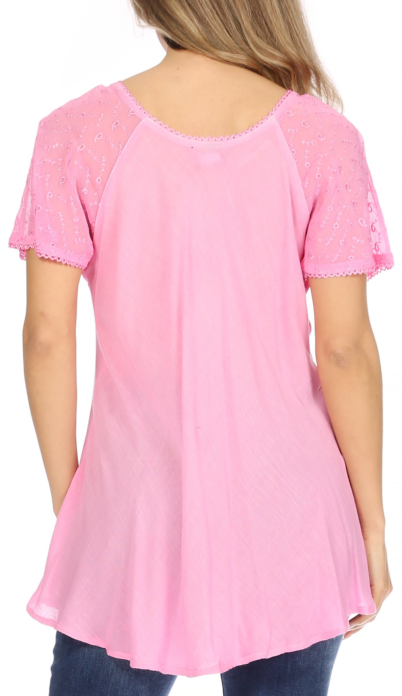 Pink lace-trimmed top worn by a person on a white background