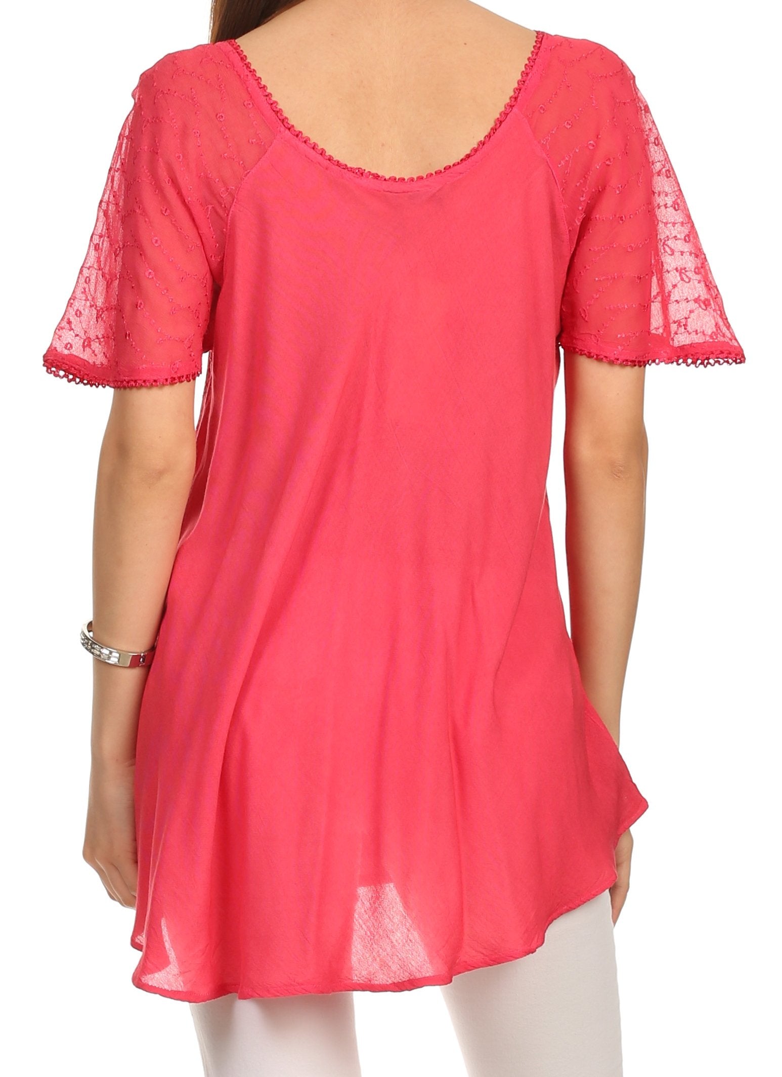 Pink lace-trimmed top worn by a person on a white background