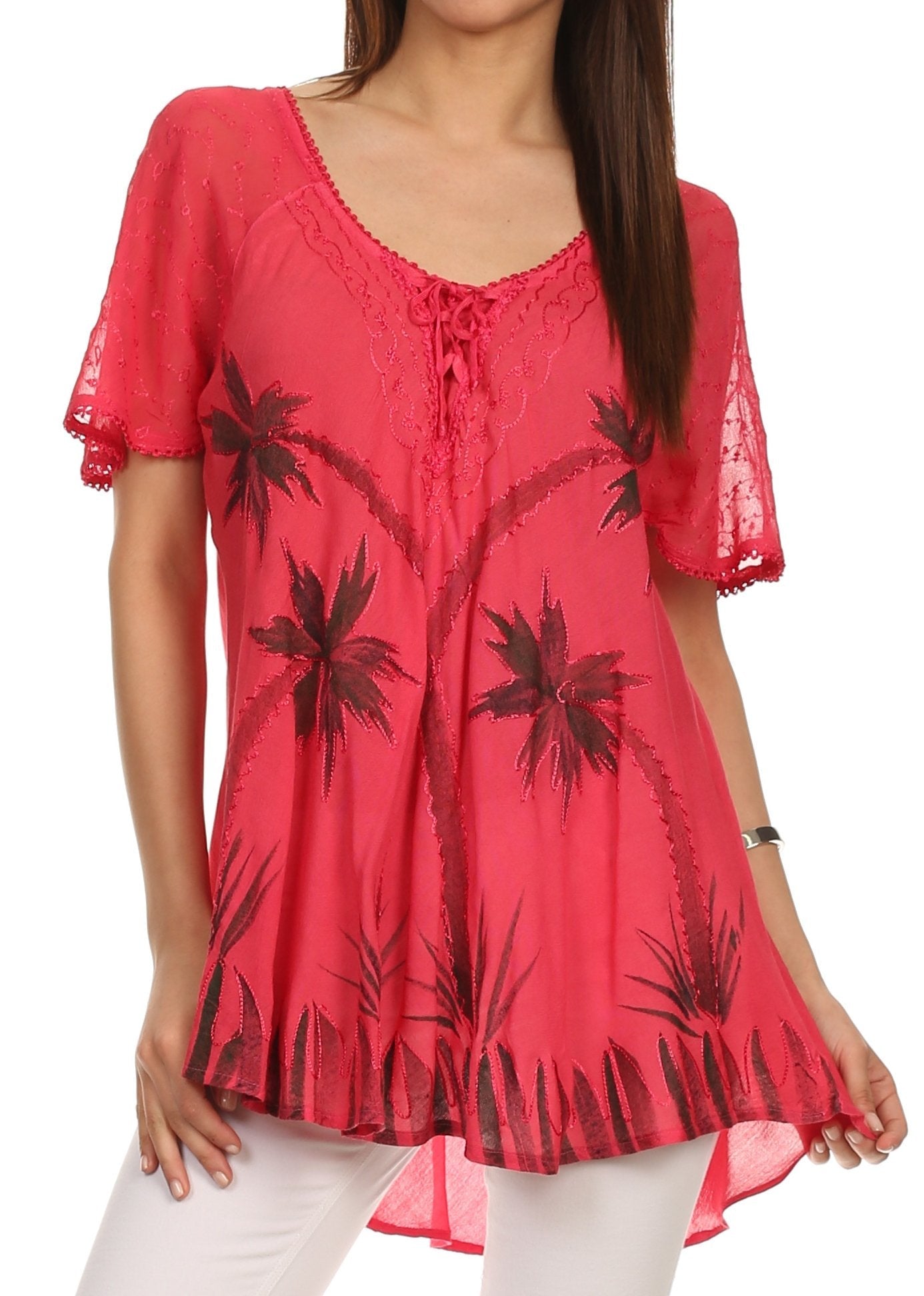 Red blouse with black palm tree patterns worn by a model on a white background
