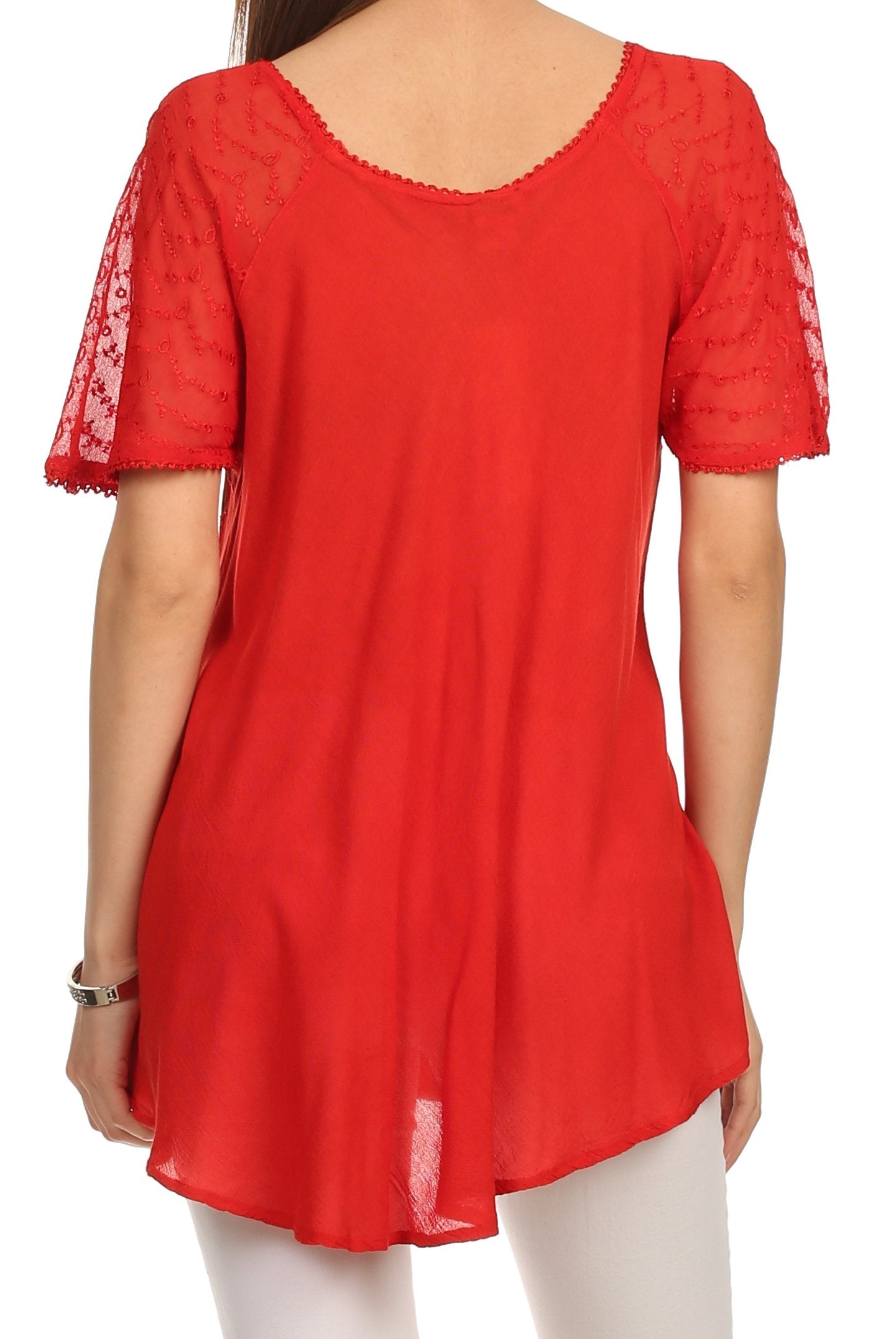 Red lace-trimmed top worn by a person on a white background
