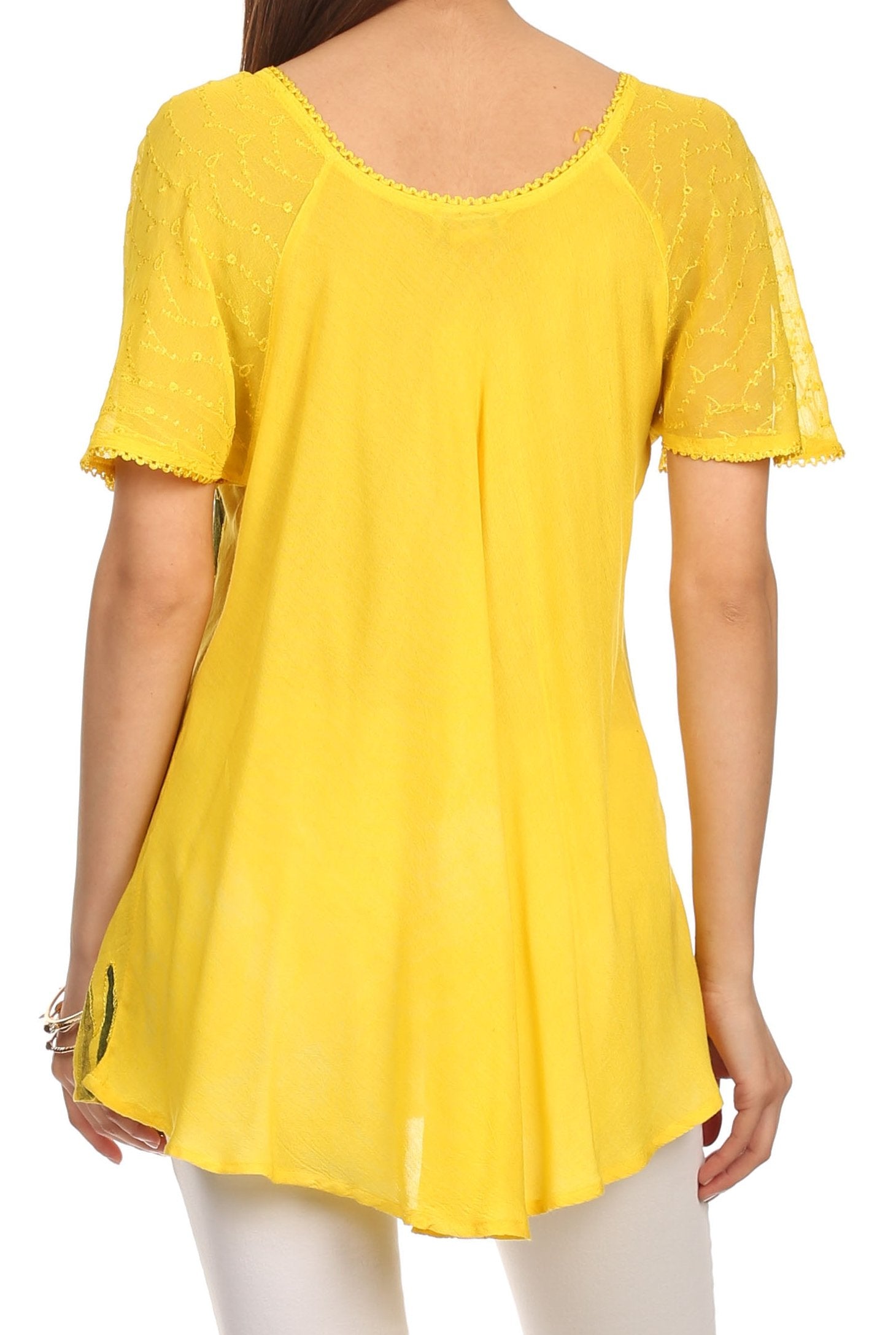 Yellow top worn by a person on a white background