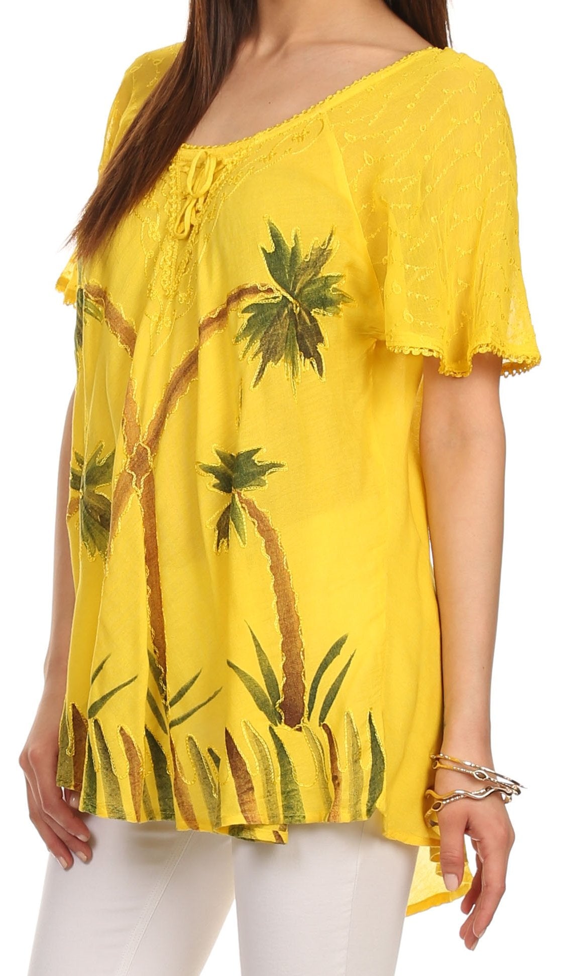 Yellow blouse with palm tree design worn by a person
