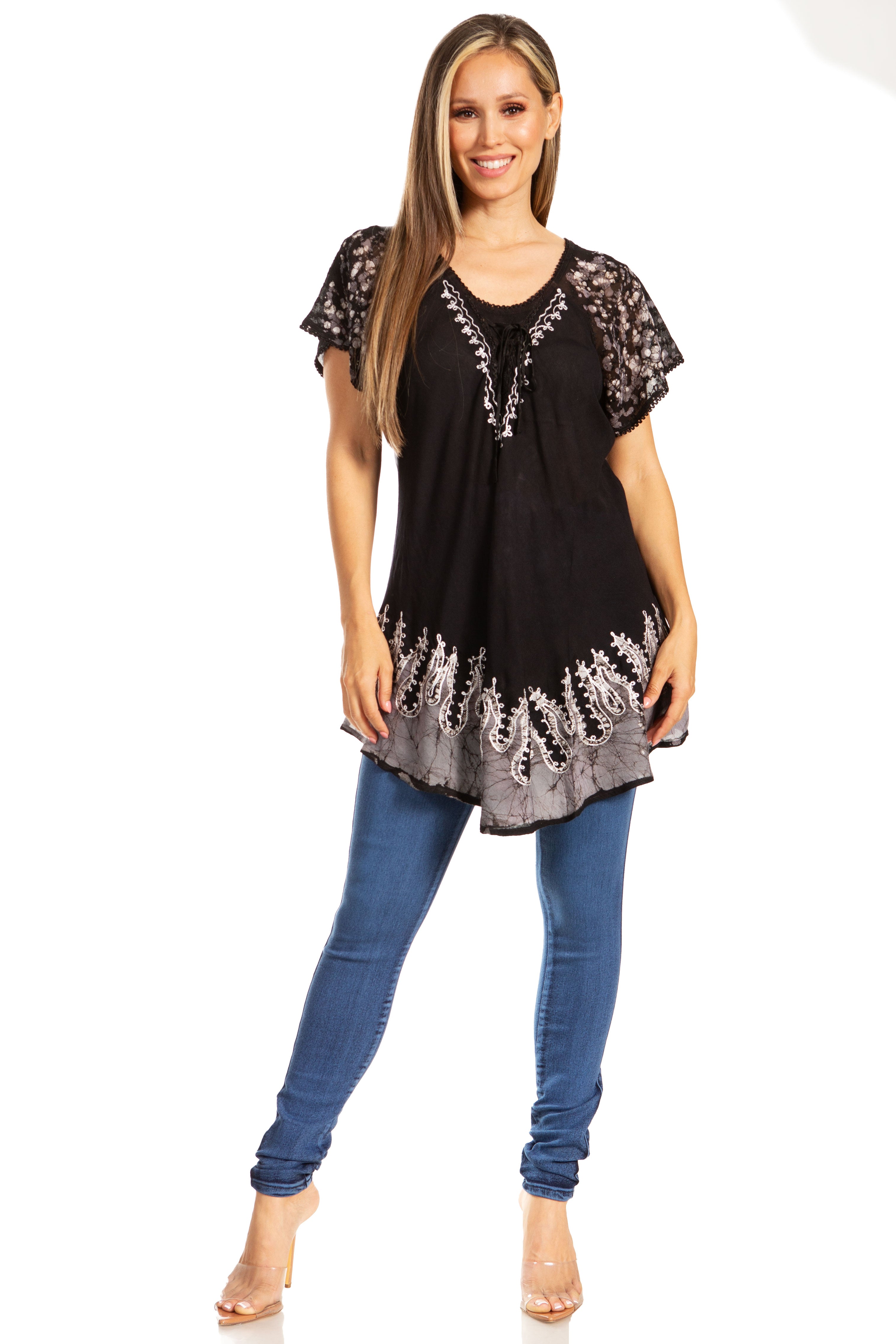Woman wearing a black lace top and blue jeans on a white background