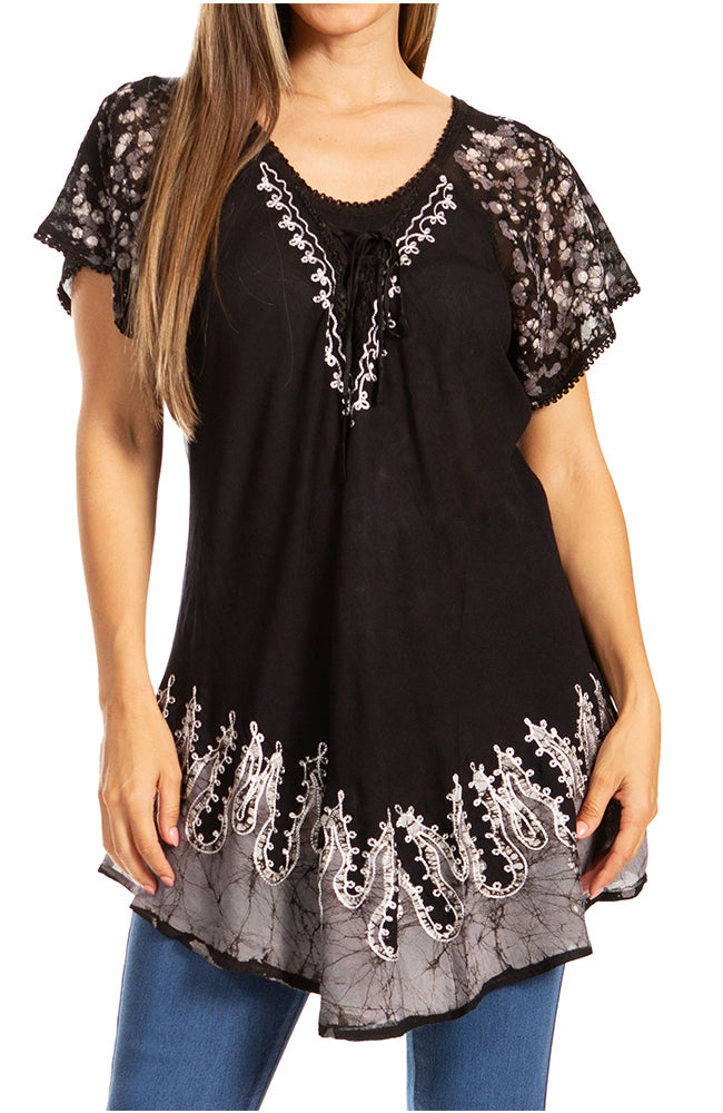 Black lace-trimmed top worn by a person on a white background
