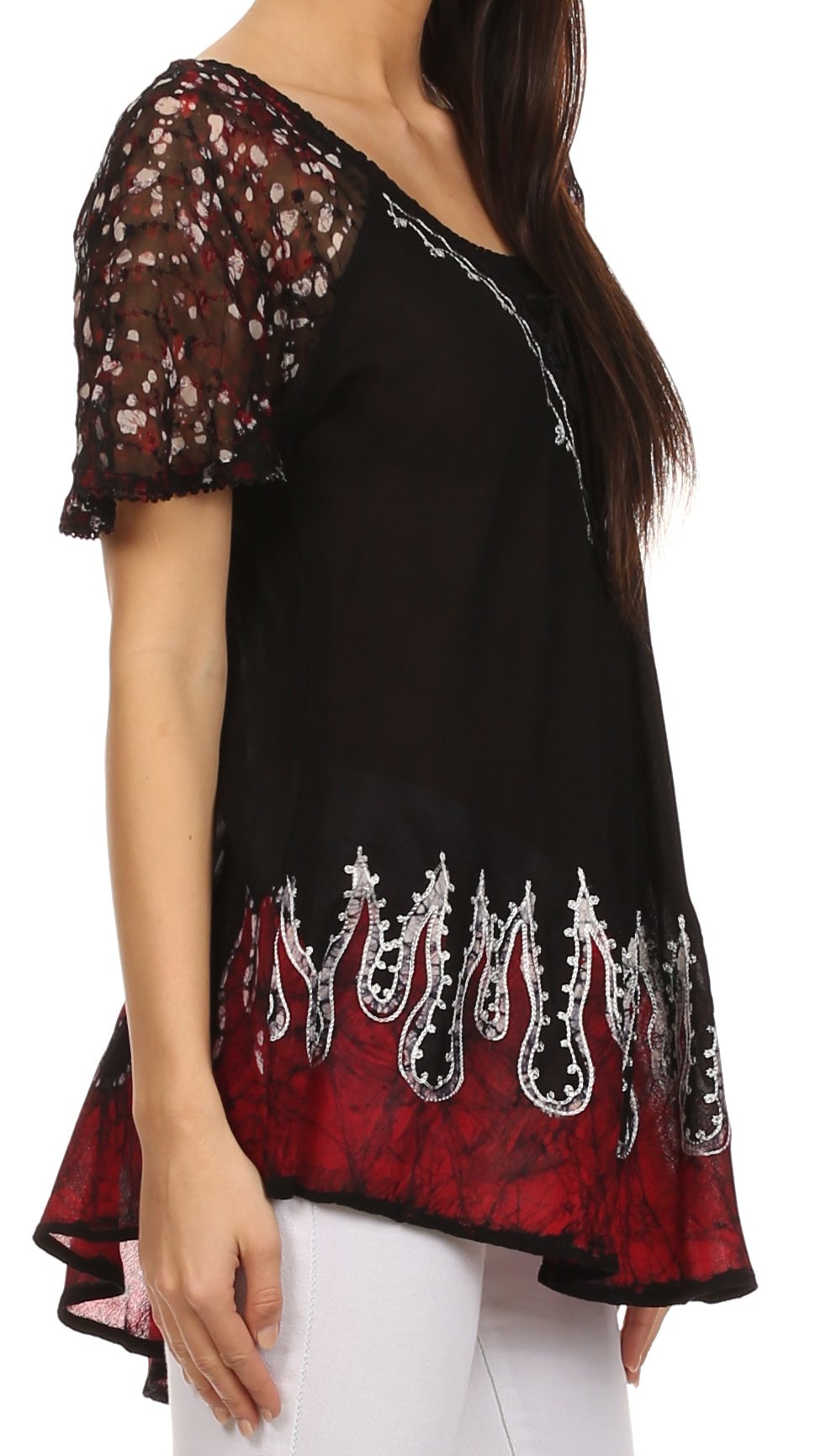 Black and red patterned top worn by a person on a white background