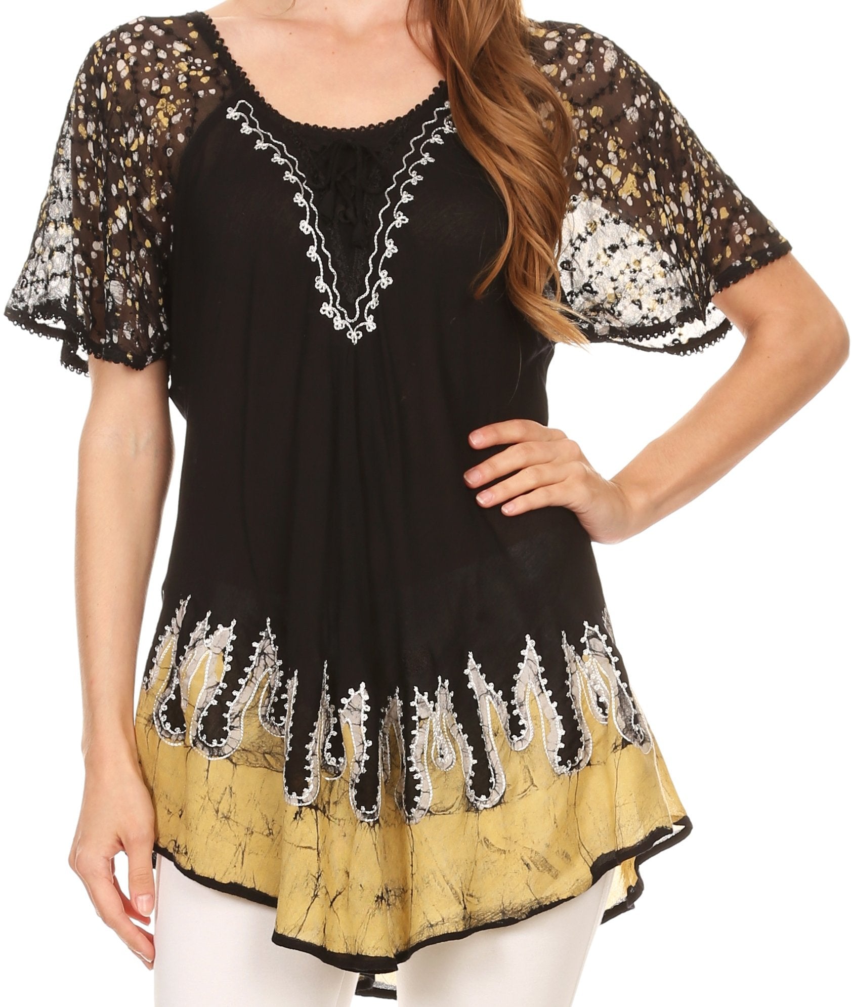 Black and gold lace top worn by a person on a white background