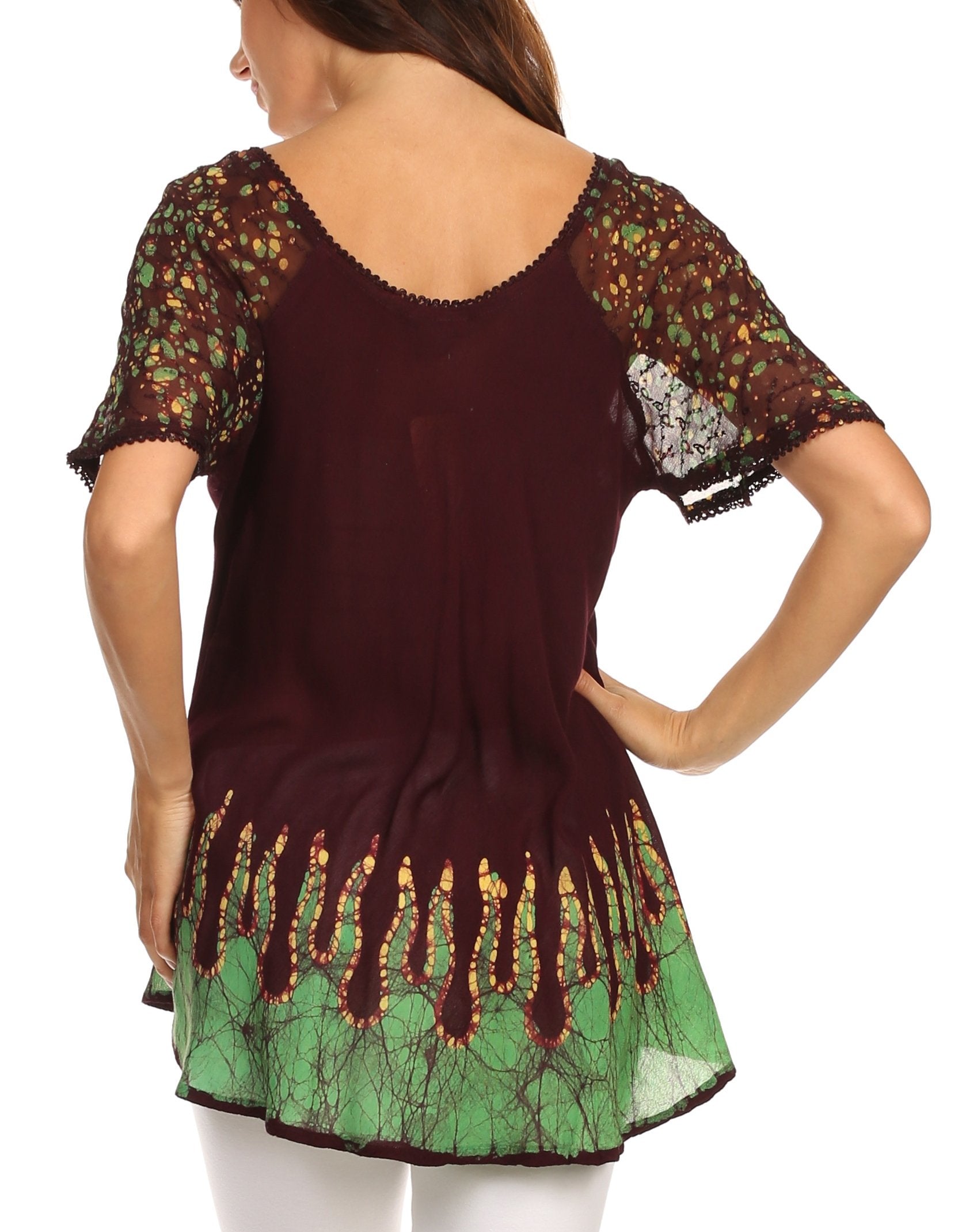 Woman wearing a dark brown and green patterned top with lace sleeves on a white background