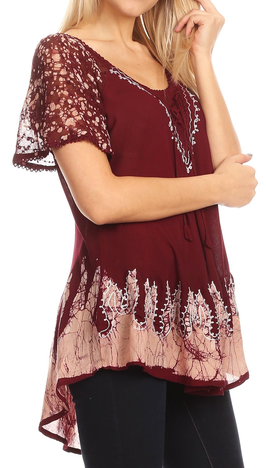Woman wearing a burgundy lace top with a plain background