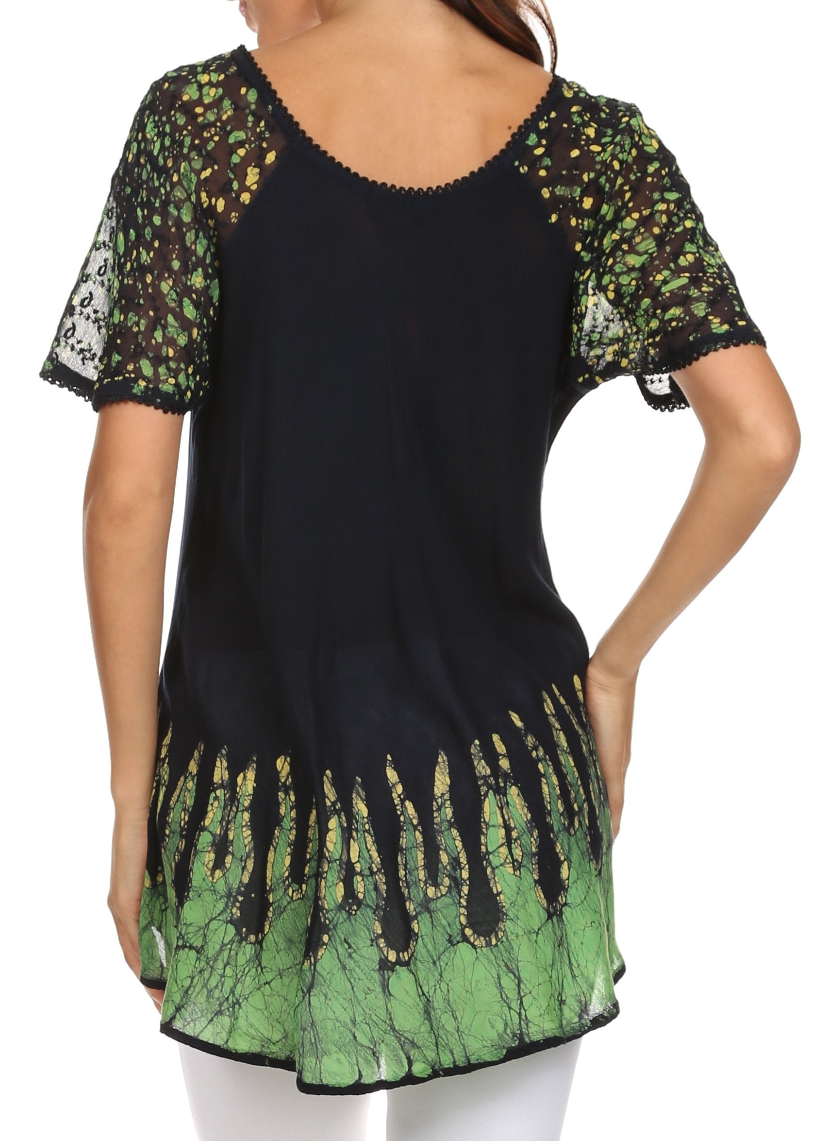 Black and green patterned top worn by a person on a white background
