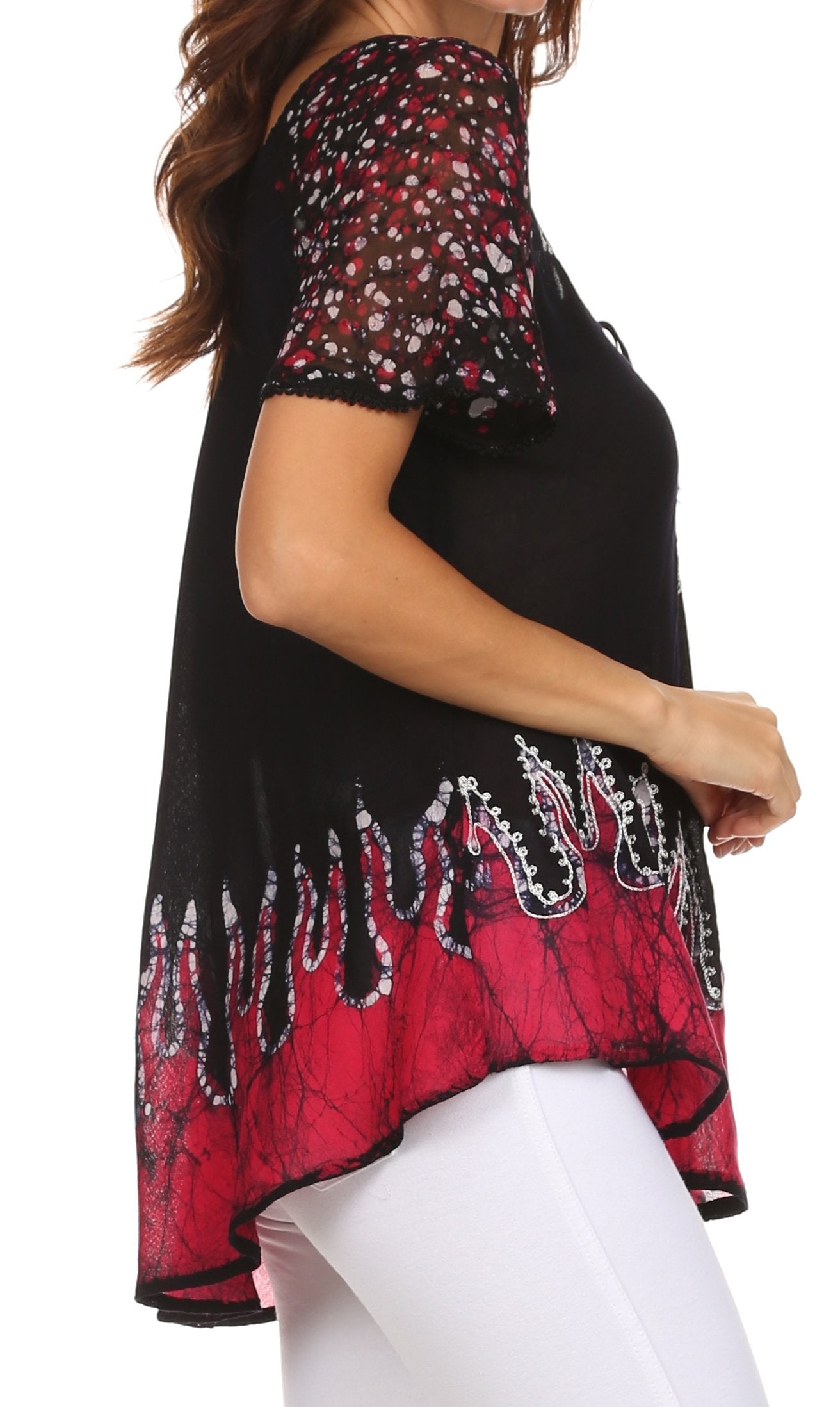 Black and red patterned top worn by a person on a white background