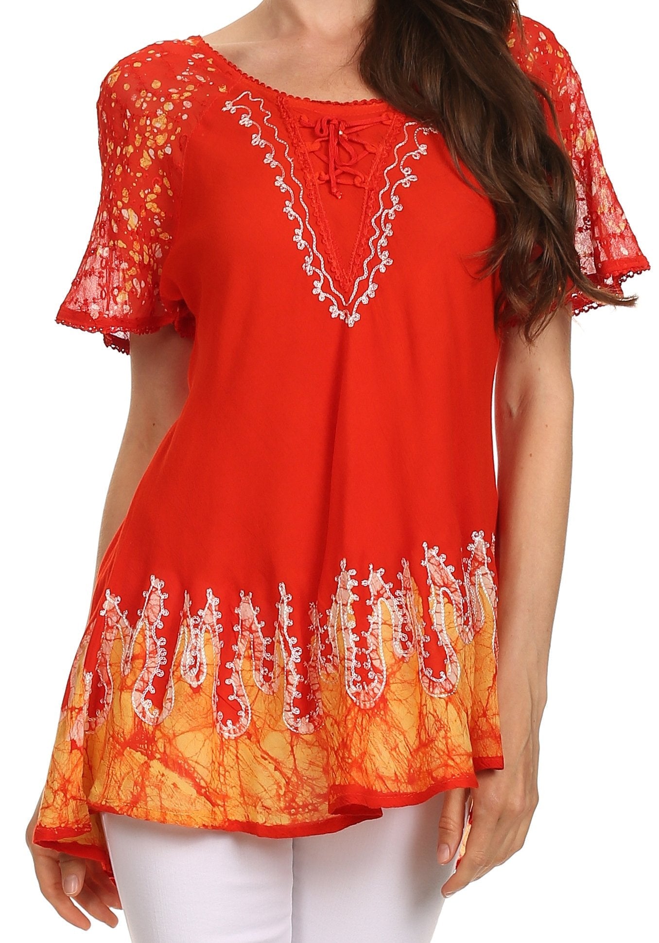 Red and orange embroidered top worn by a person on a white background