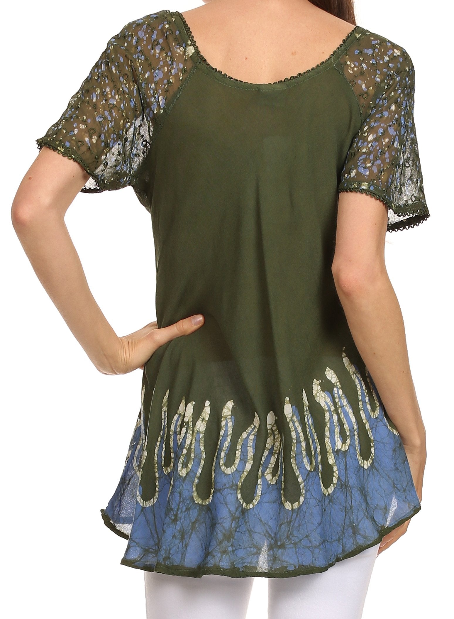 Green and blue patterned top worn by a person on a white background