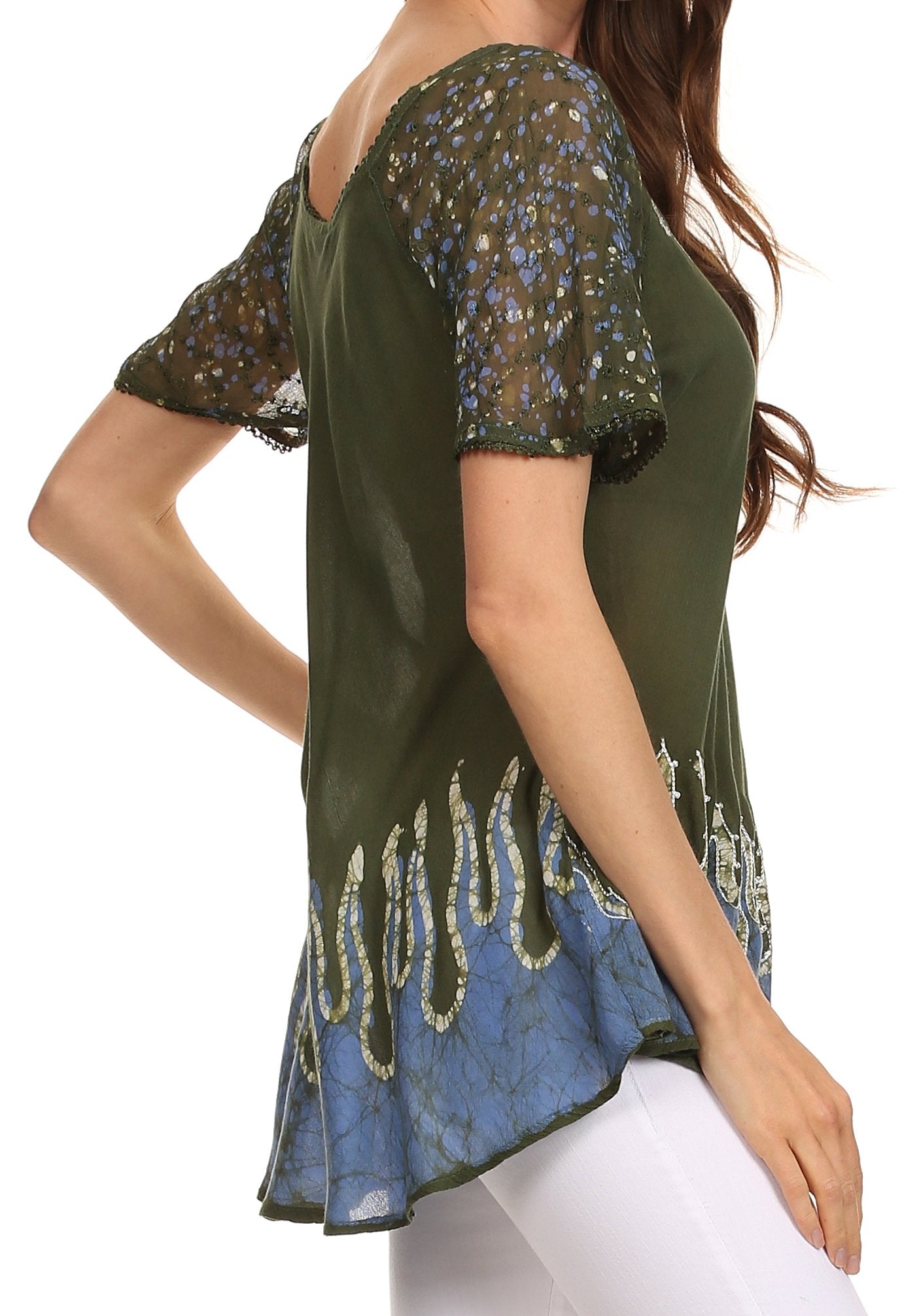 Green and blue patterned top worn by a person on a white background
