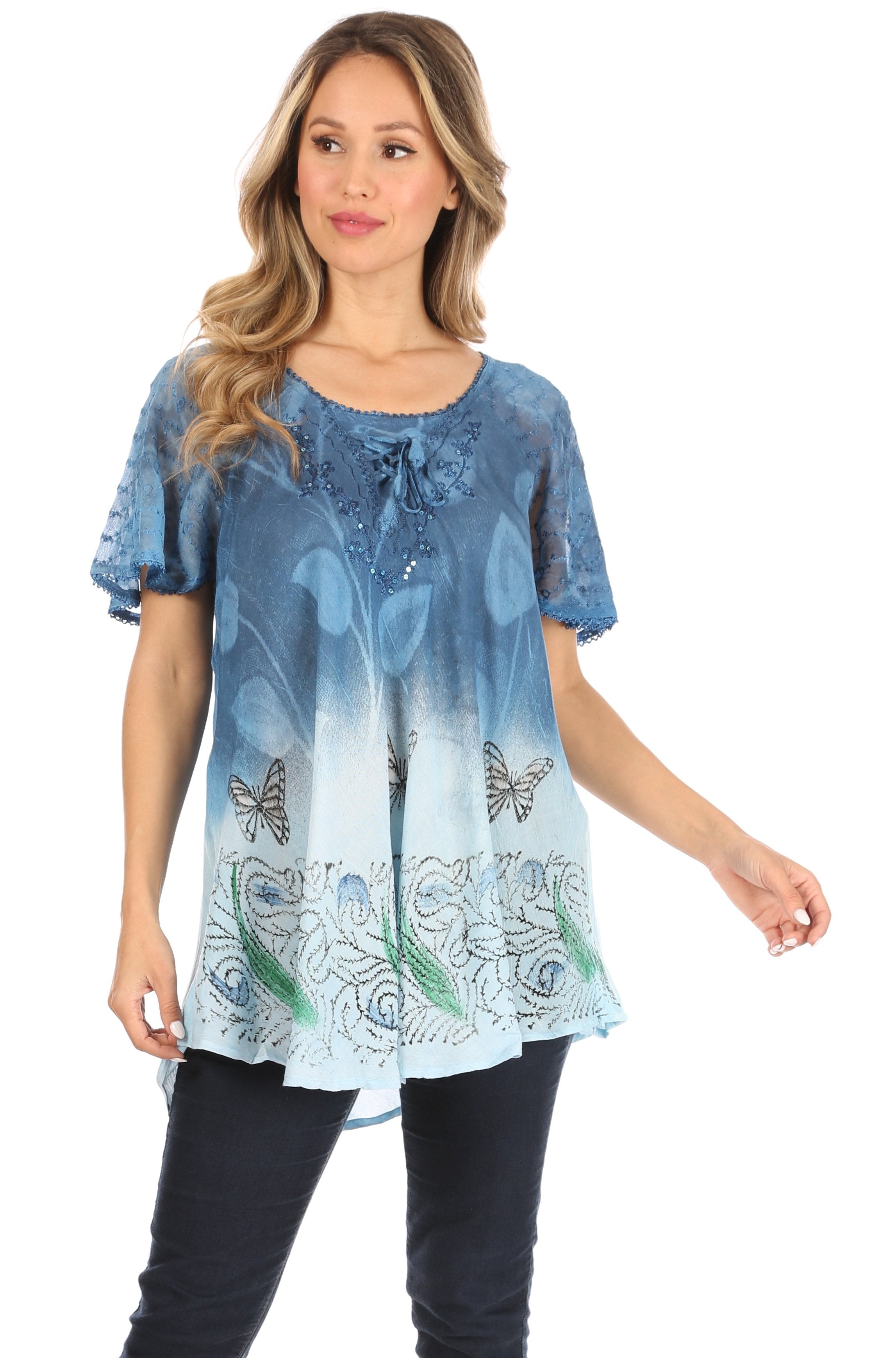 Woman wearing a blue floral blouse with butterfly designs on a white background
