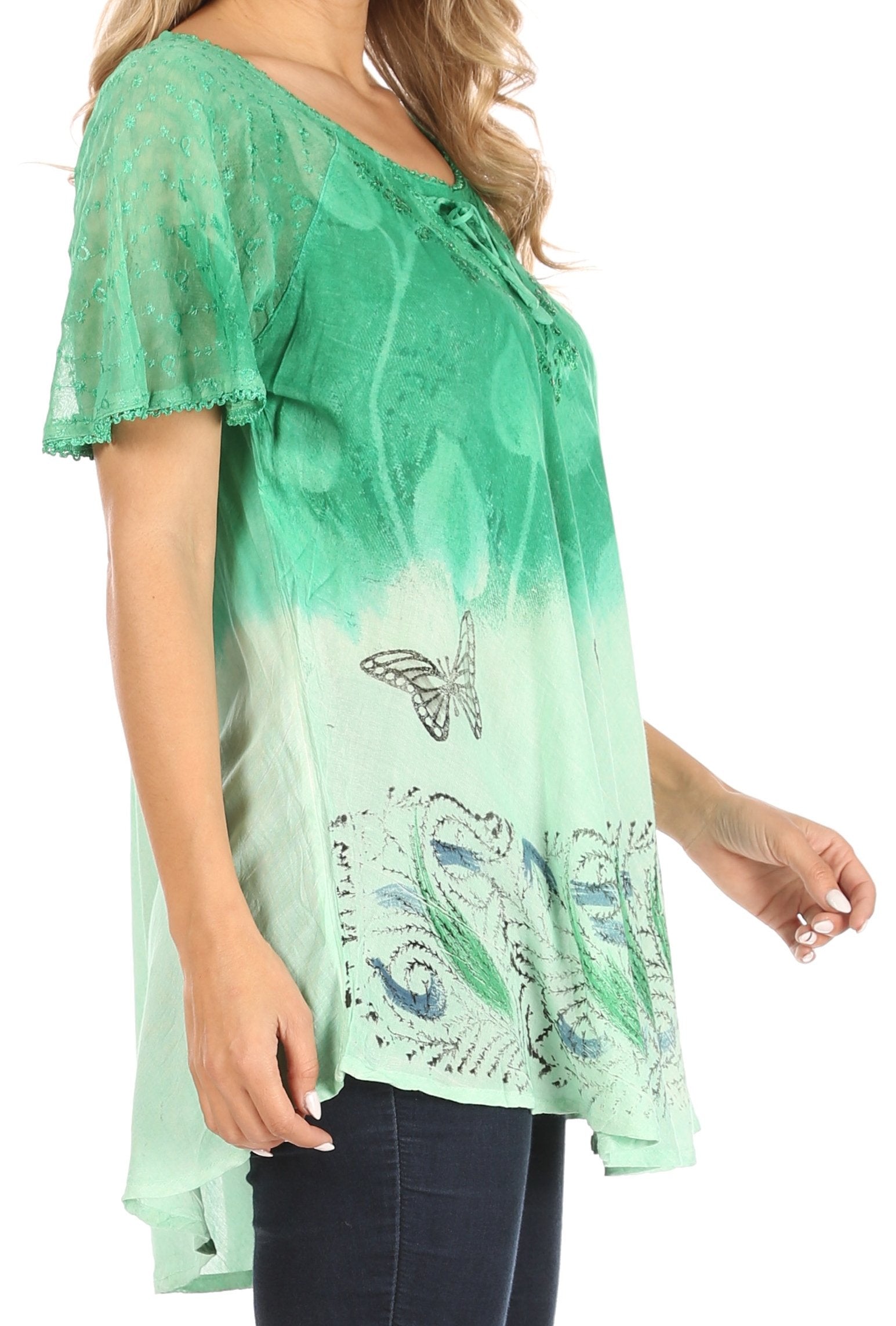 Green lace top with butterfly design worn by a person on a white background