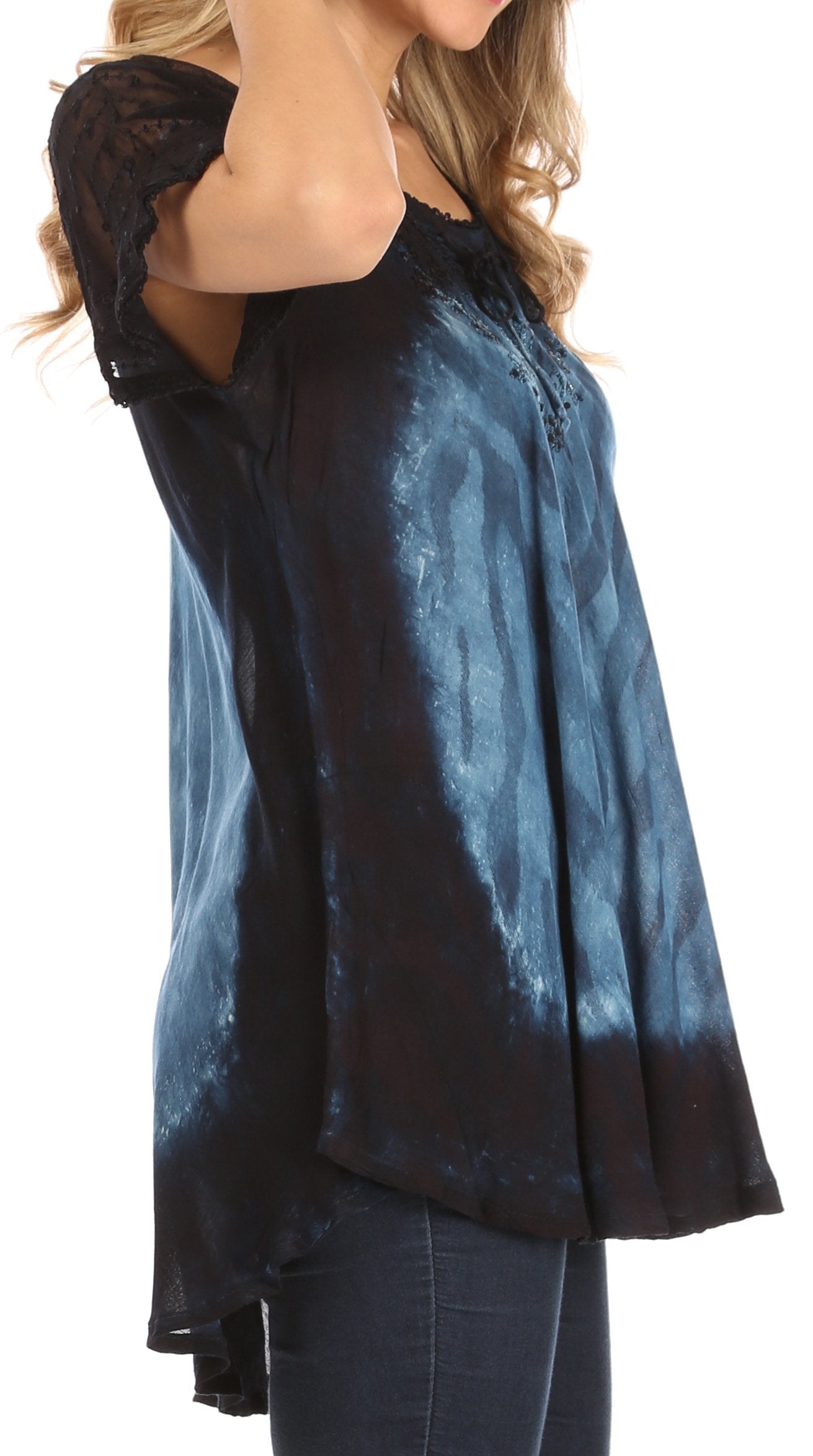 Woman wearing a blue and black tie-dye top with a plain background