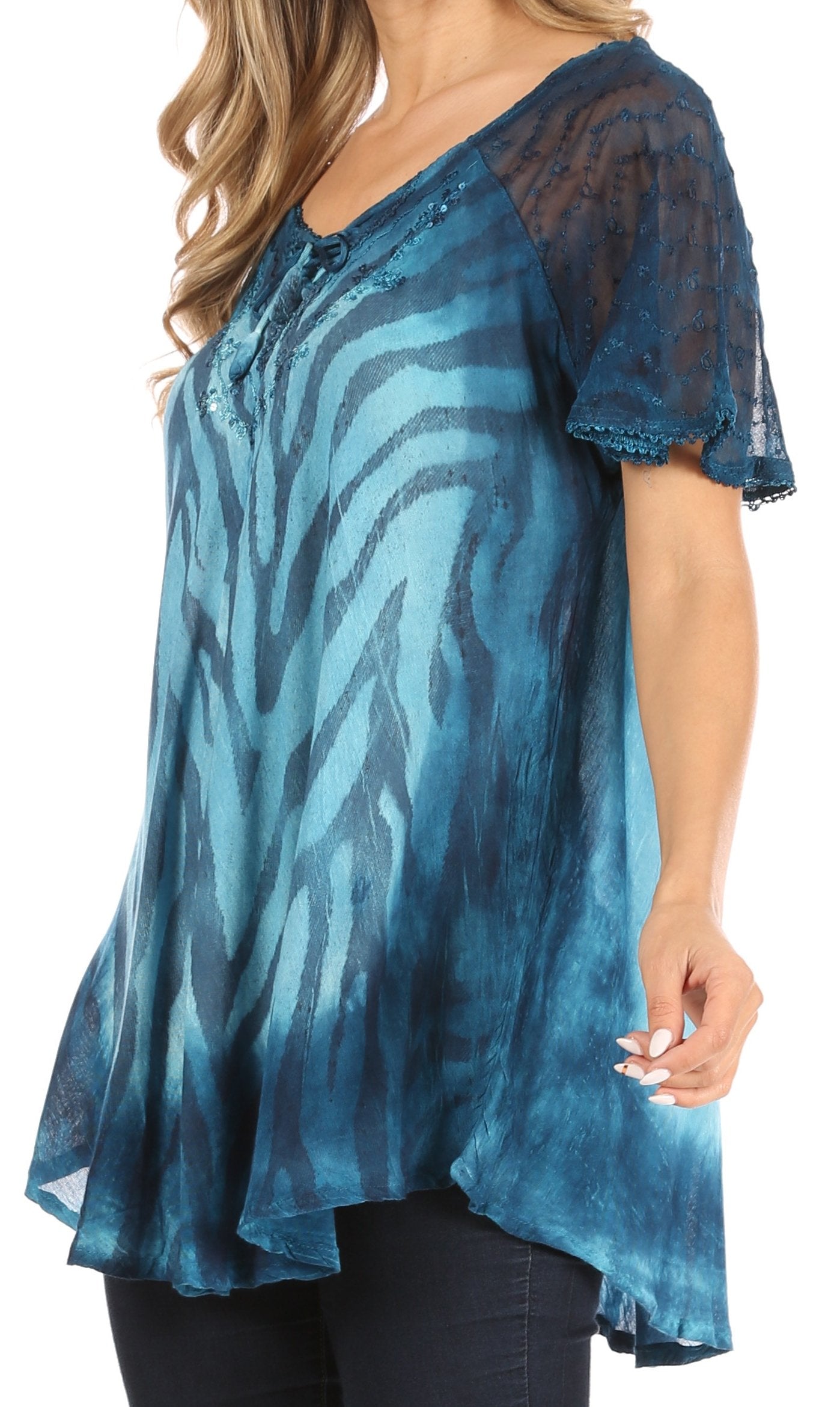 Blue patterned top worn by a person on a white background