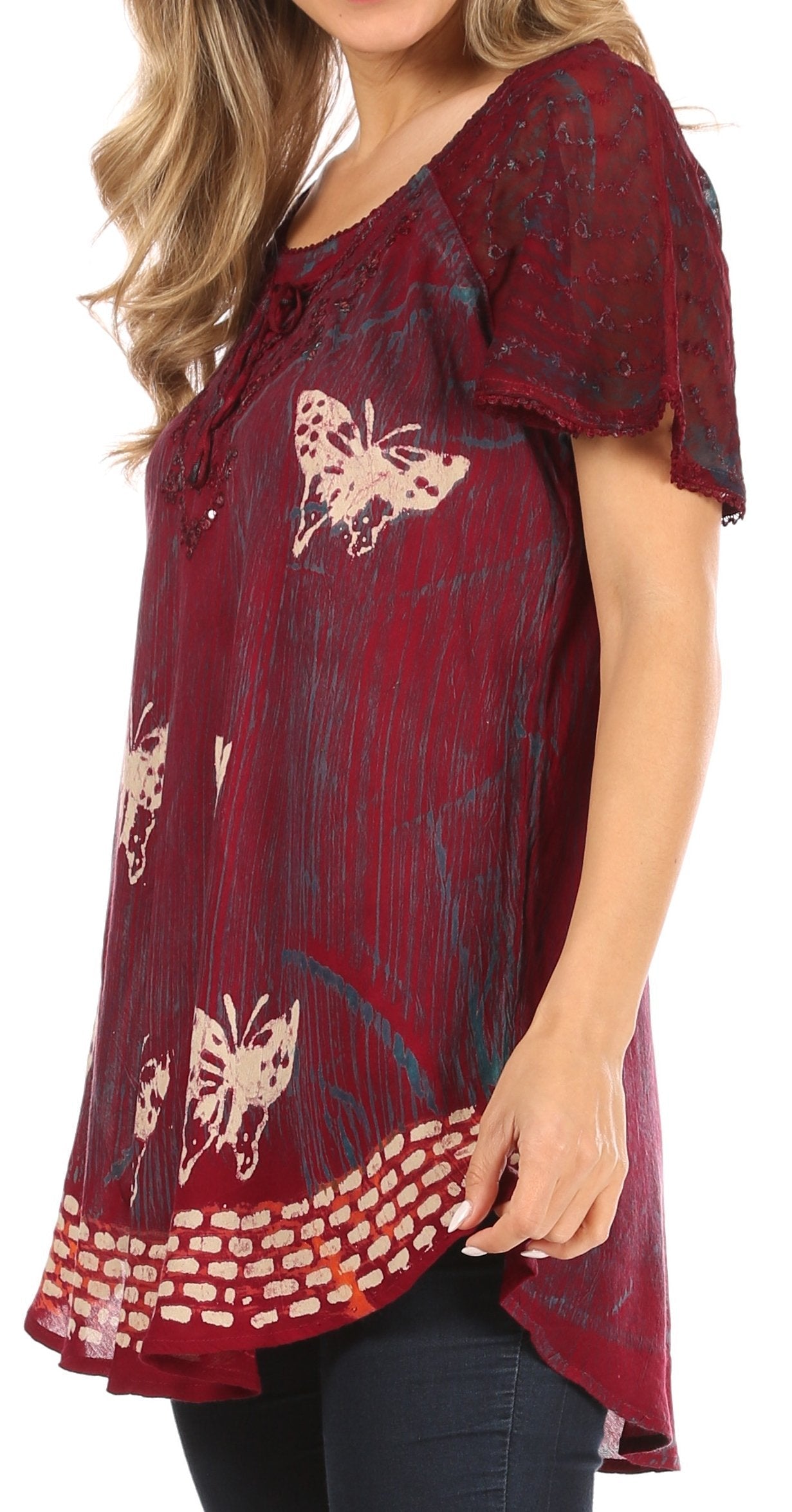 Red patterned blouse worn by a person on a white background