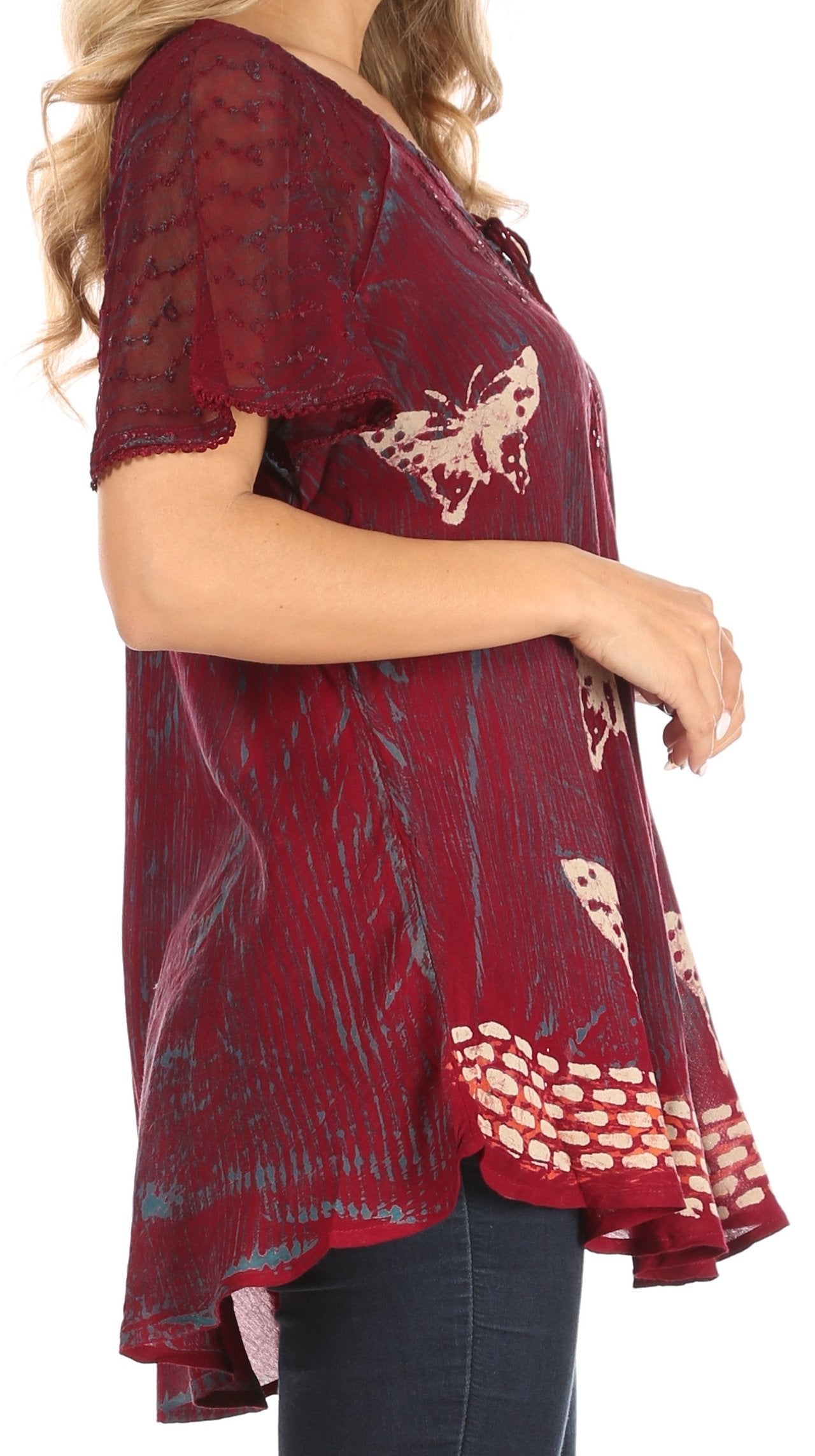 Red lace top with butterfly designs worn by a person on a white background