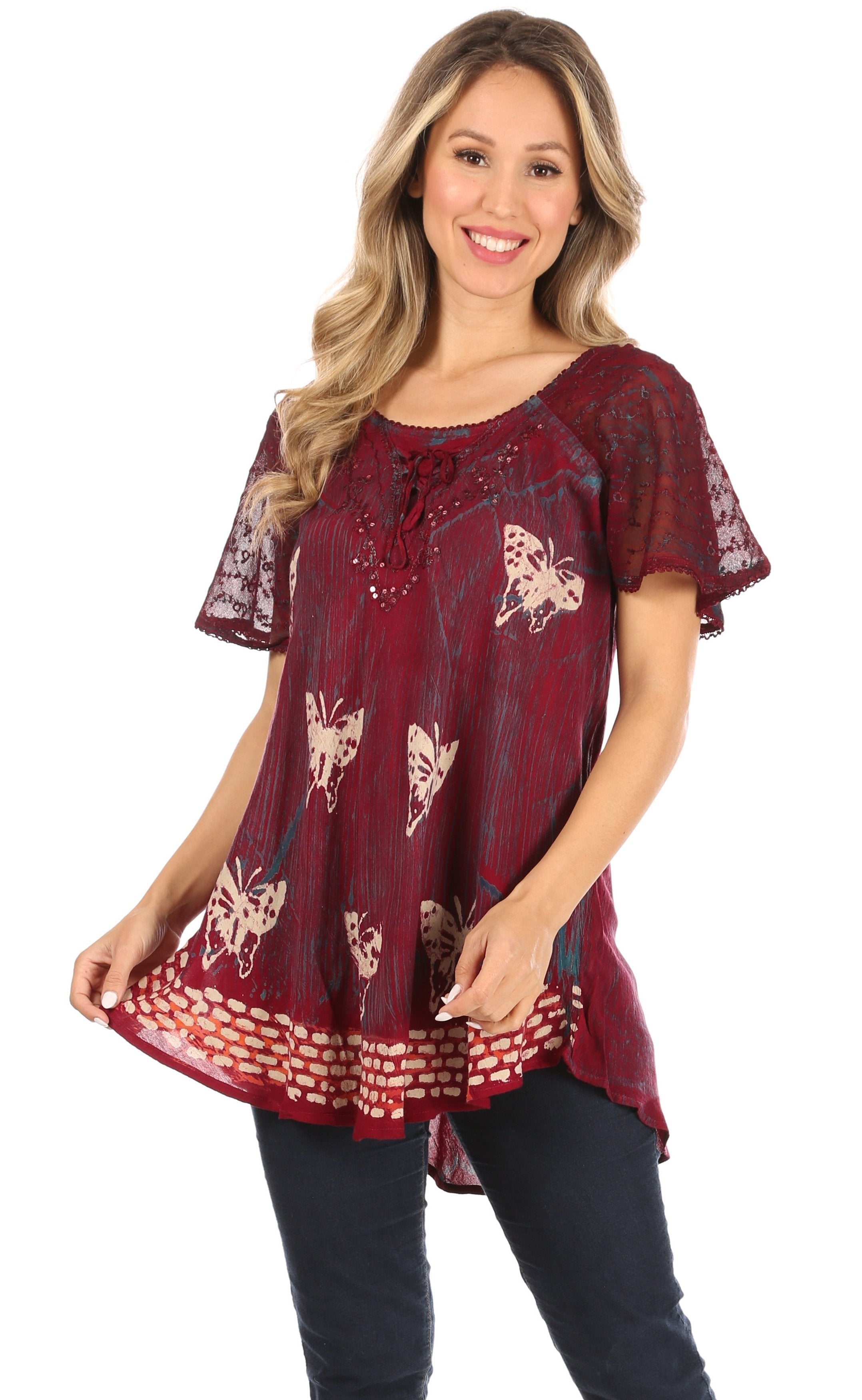 Woman wearing a burgundy patterned top on a white background