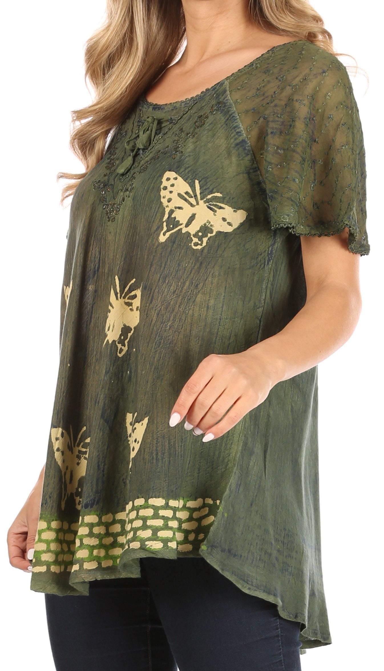 Green lace top with butterfly patterns worn by a person