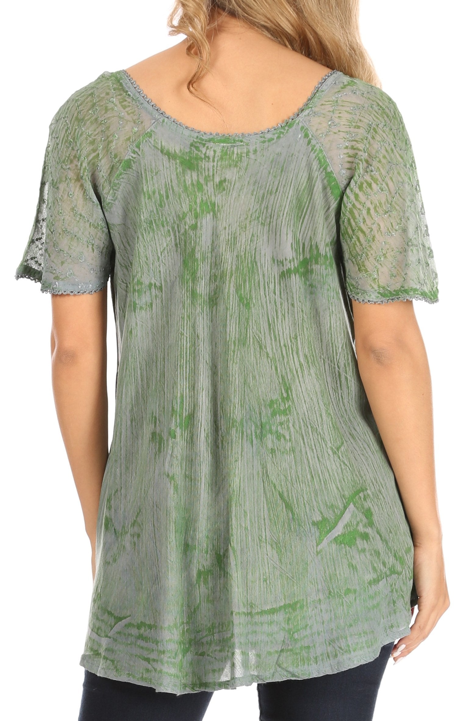 Green and gray patterned top worn by a person on a white background