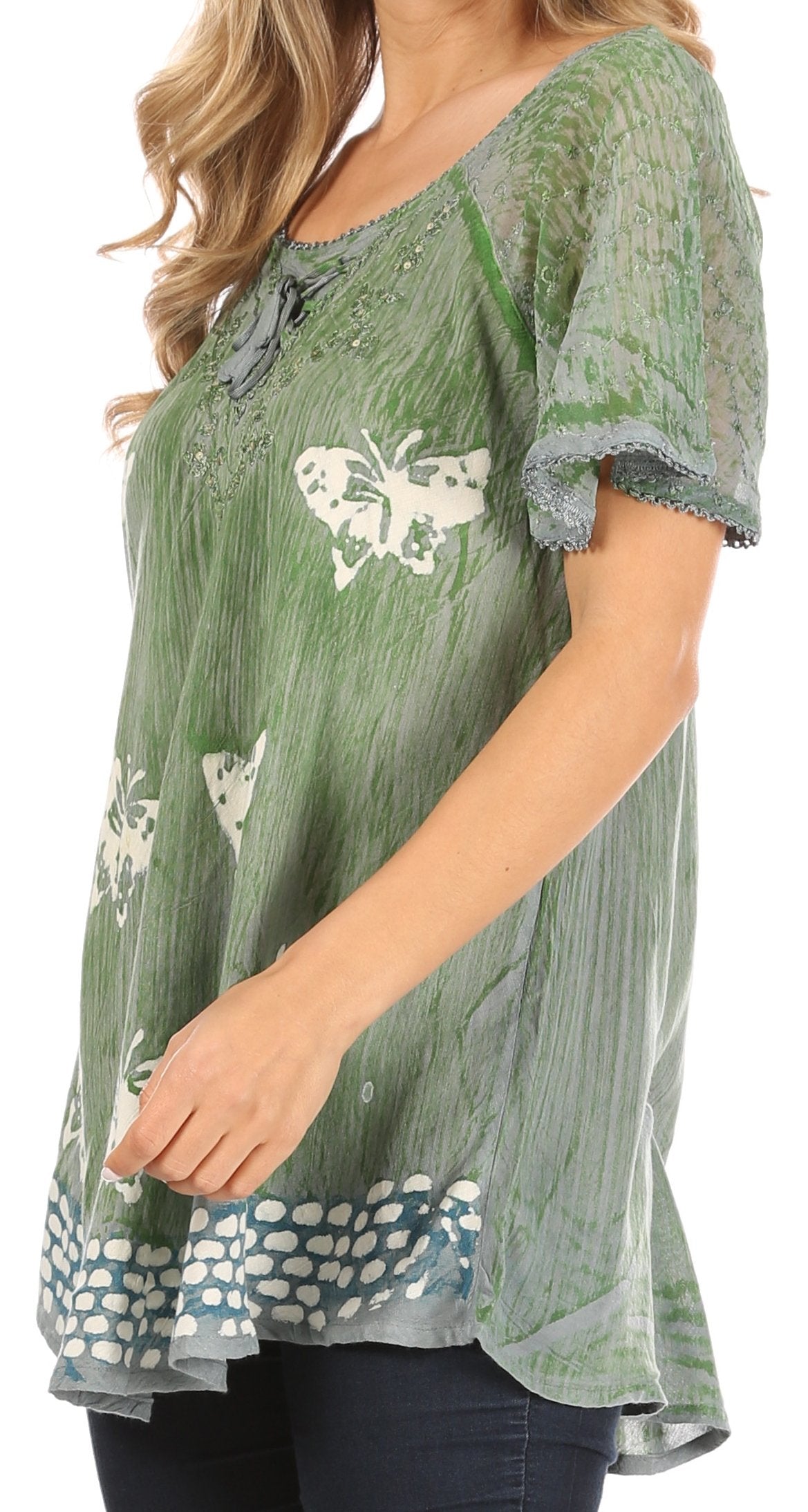 Green lace-trimmed top with butterfly designs worn by a person