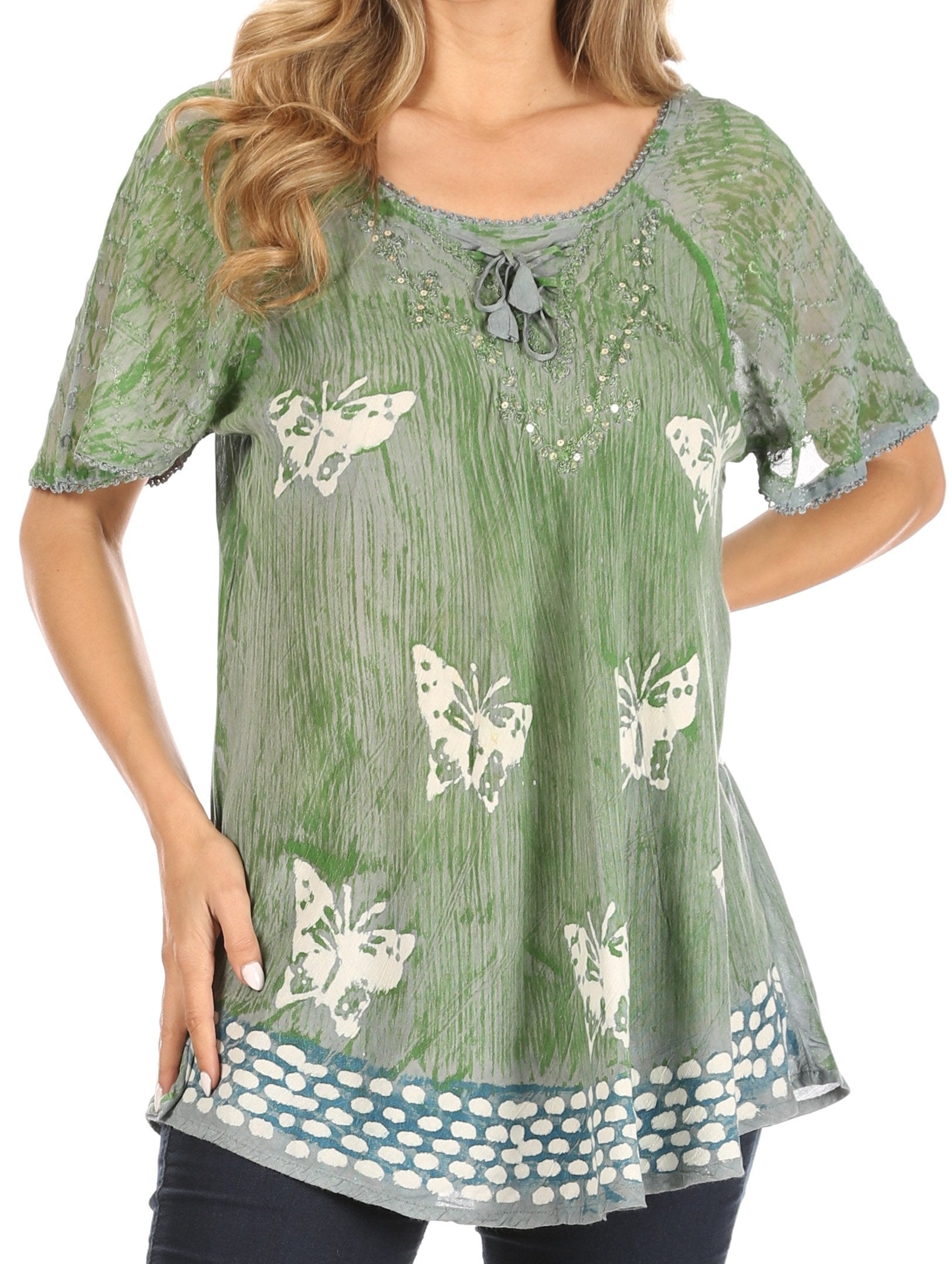 Green blouse with butterfly patterns worn by a model on a white background