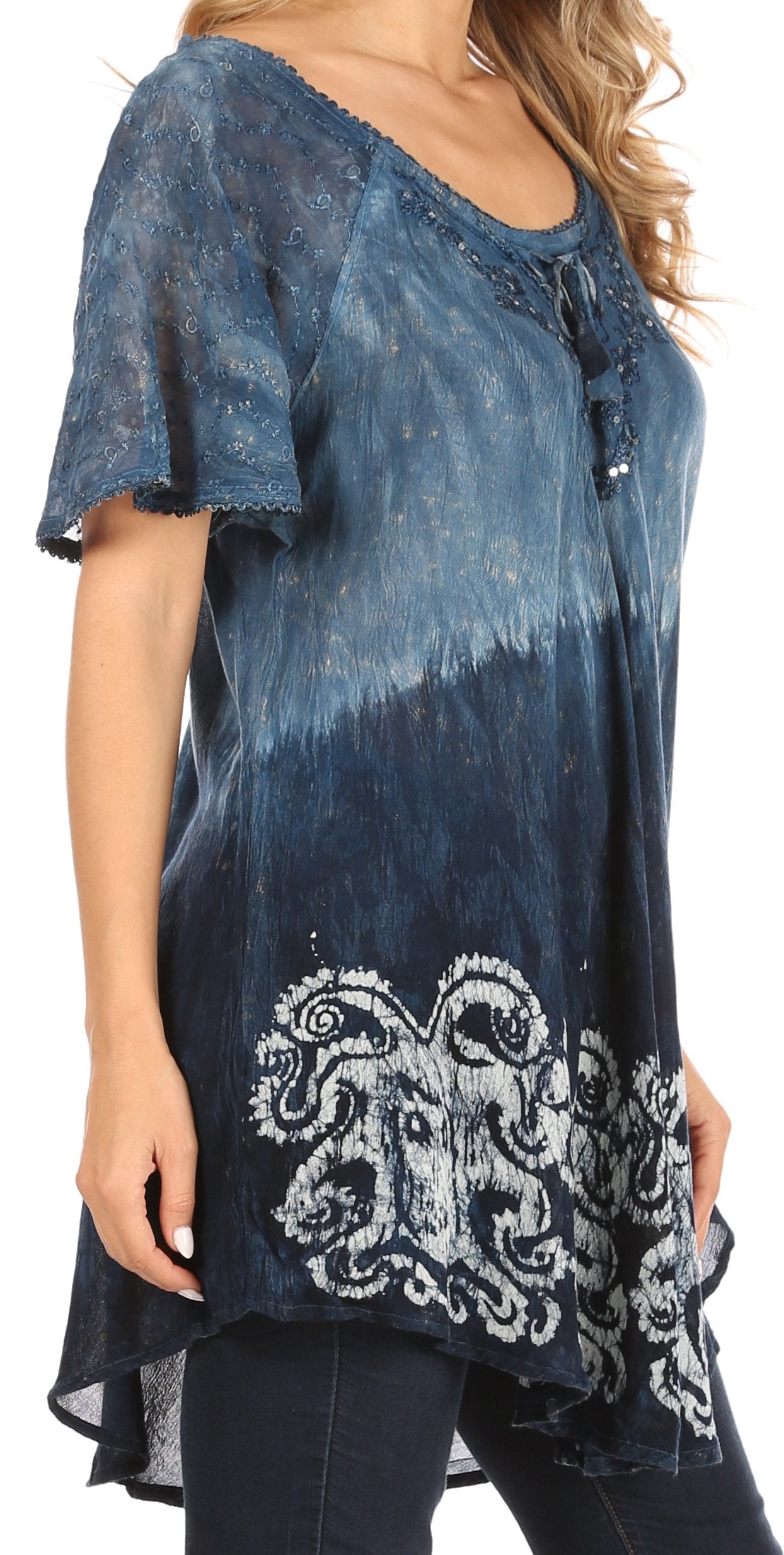 Blue tie-dye top with lace details and embroidery on a white background